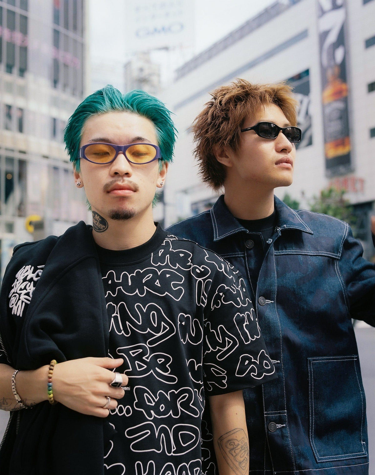 Two models in Tokyo wearing the AOP Graf T-shirt in Black and Sound Clash Denim Jacket in Navy/Blue.