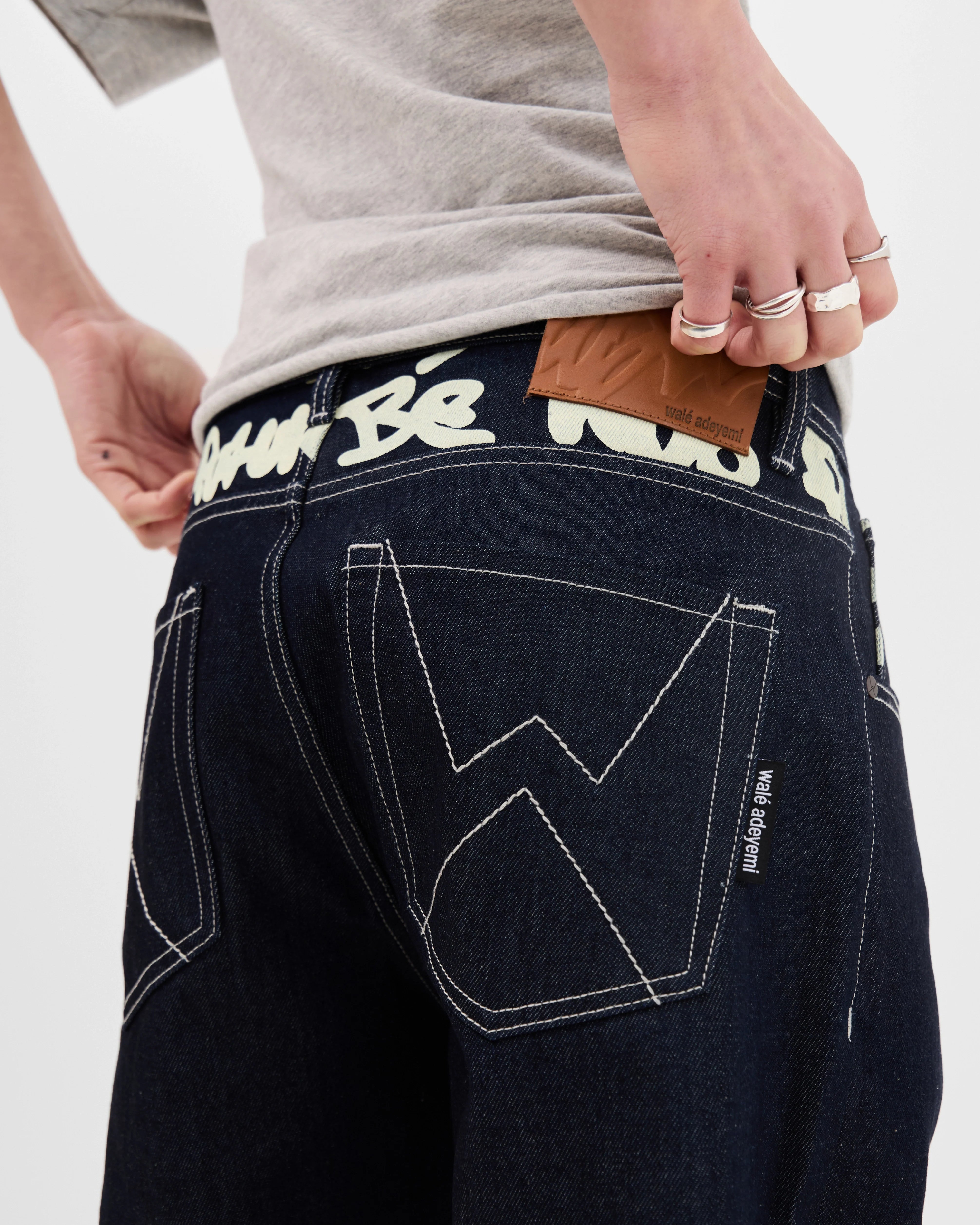Close-up of the back waistband on the Walé Adeyemi Archive Graf Denim Jeans in Navy/Lemon