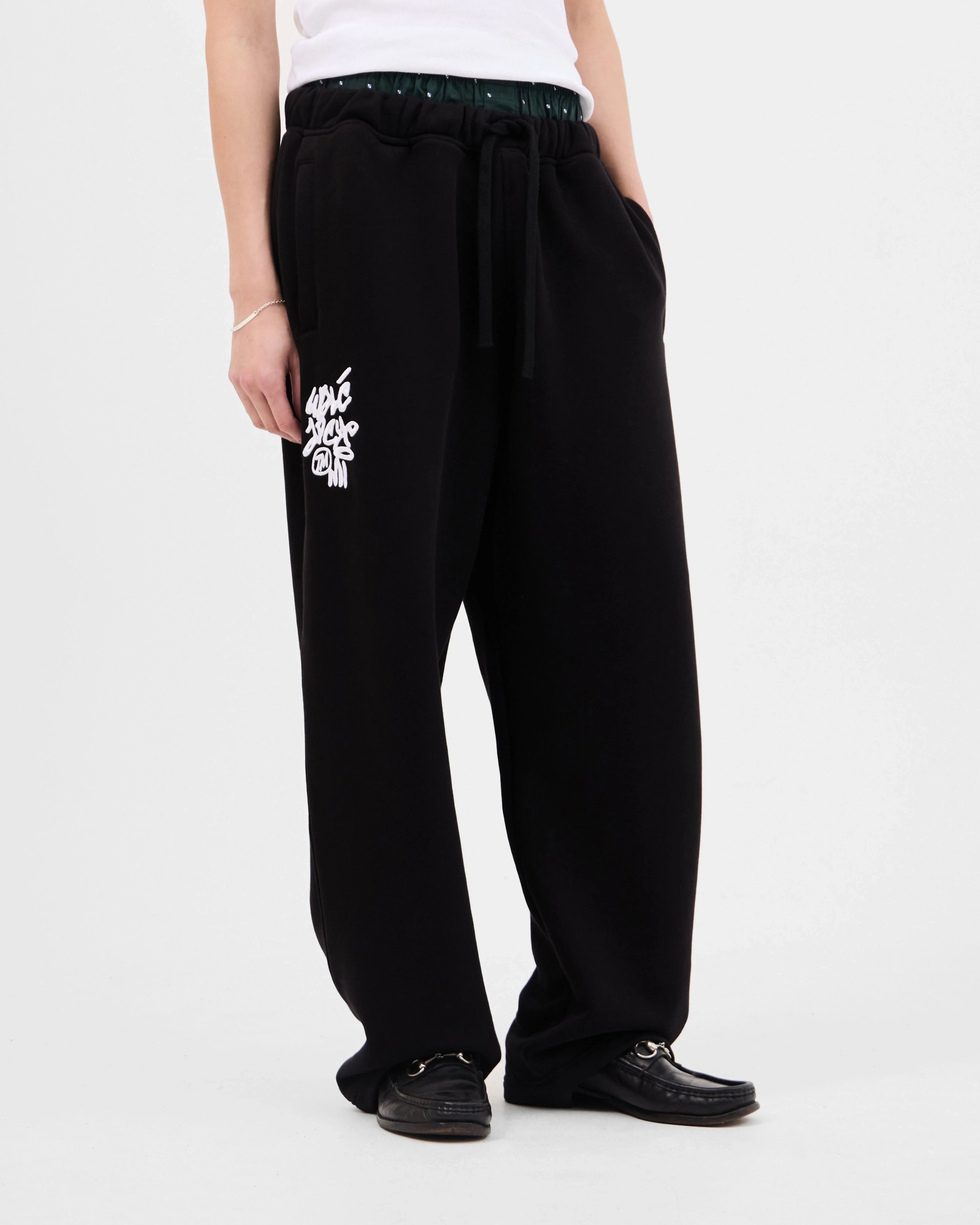 Walé Adeyemi Vinnie Joggers in Black/White, front flat-lay view with graffiti logo print on the thigh