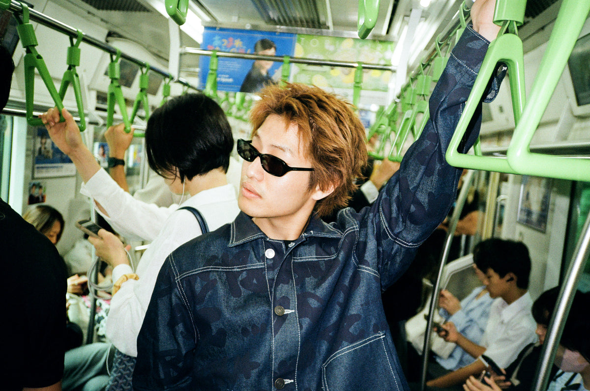 The model is wearing Wale Adeyemi's navy blue denim jacket in the metro