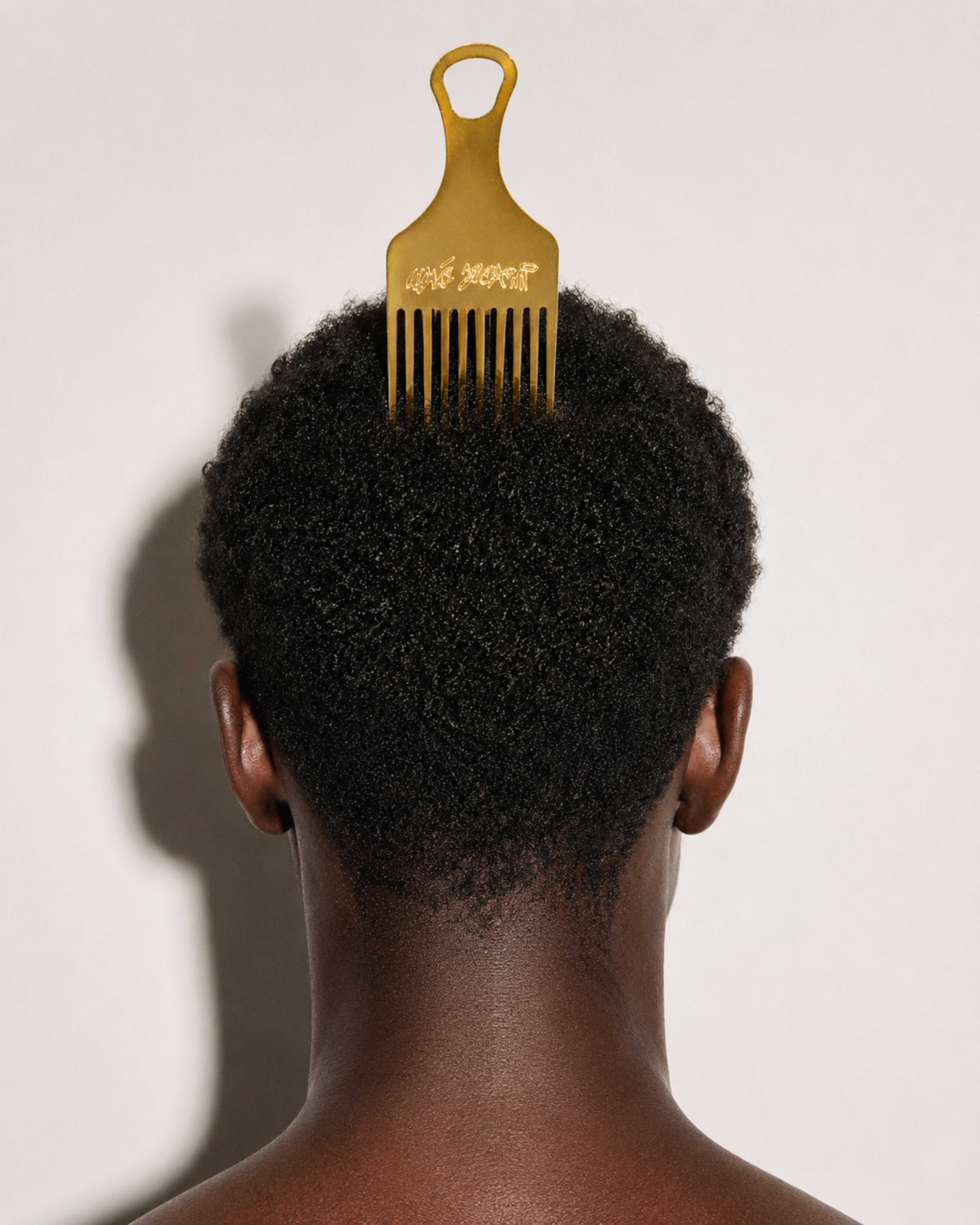 Model wearing the Walé Adeyemi Roots Comb in Gold, back hairstyle view