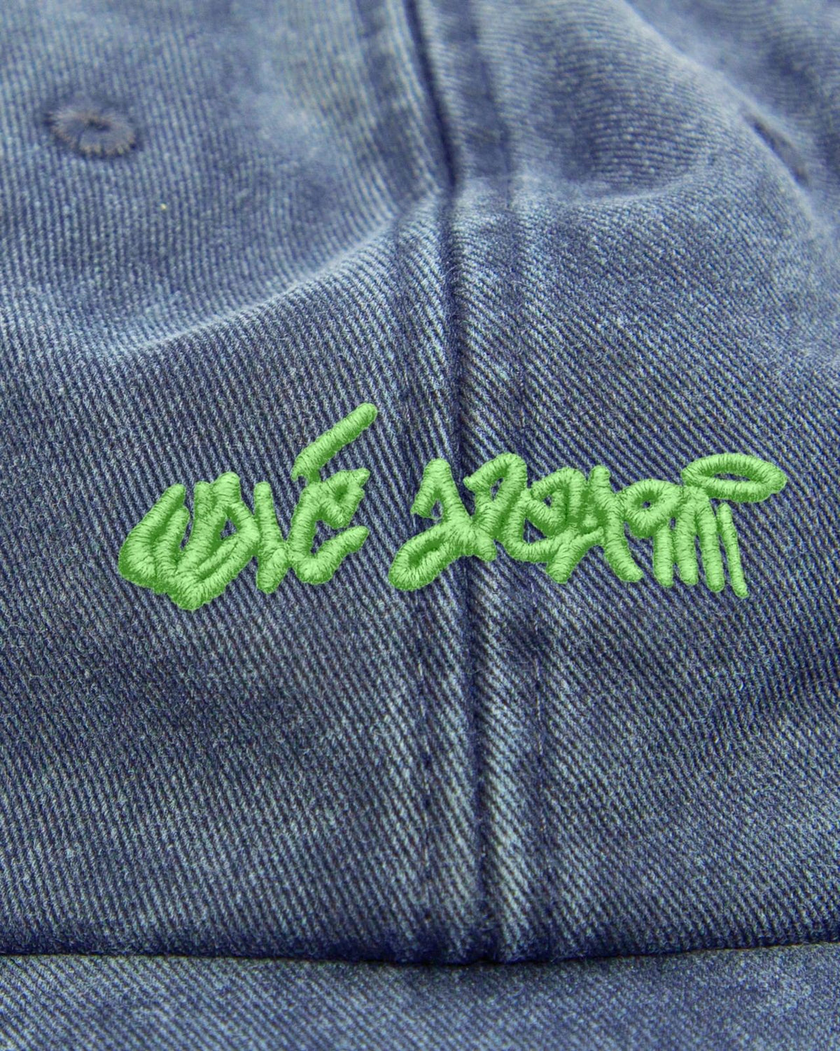 Close-up of the graffiti embroidery on the Walé Adeyemi Chorus Cap in Blue/Lime