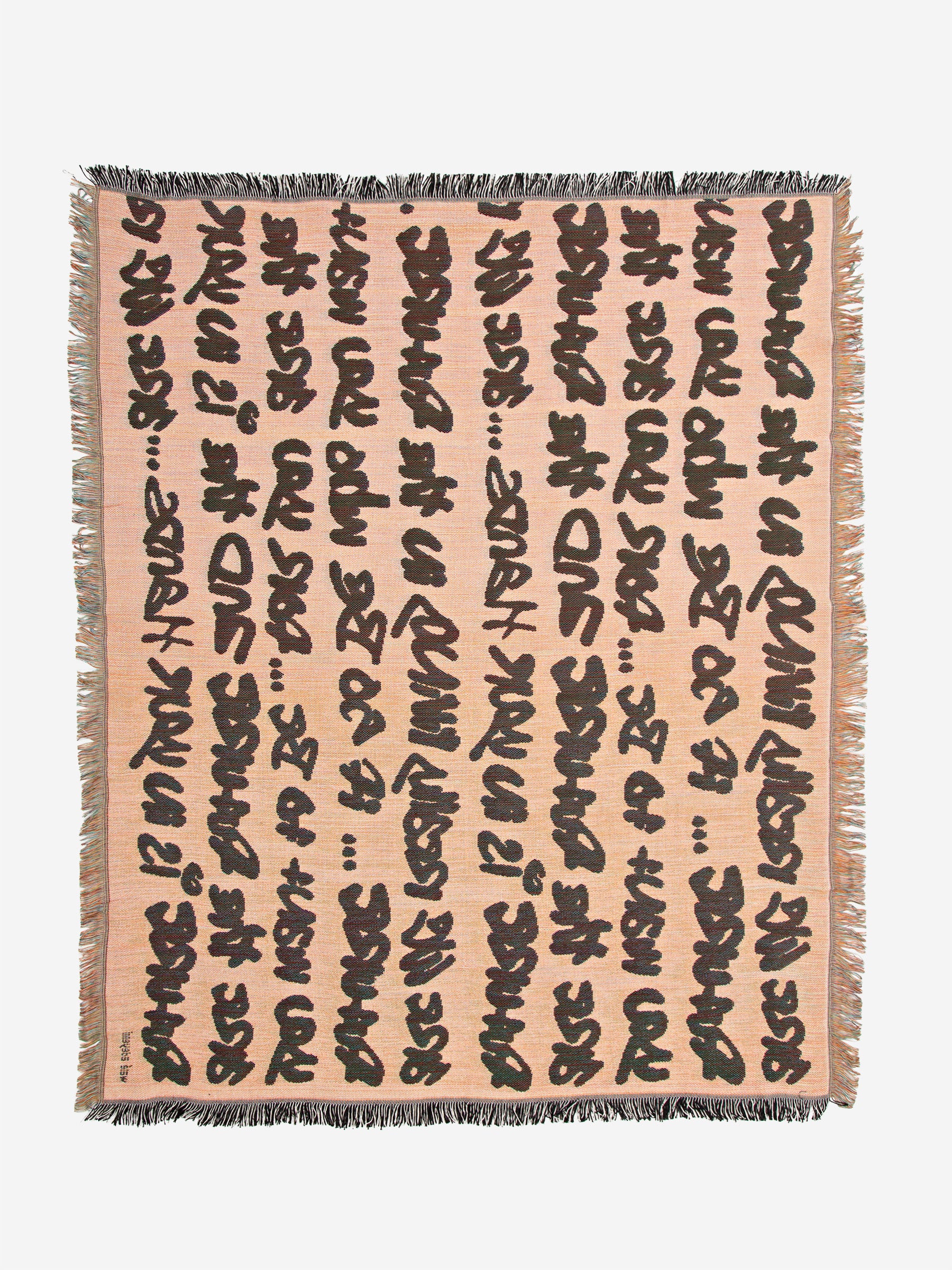 Full flat lay view of Wale Adeyemi woven throw blanket in peach beige with black typographic script and fringed border