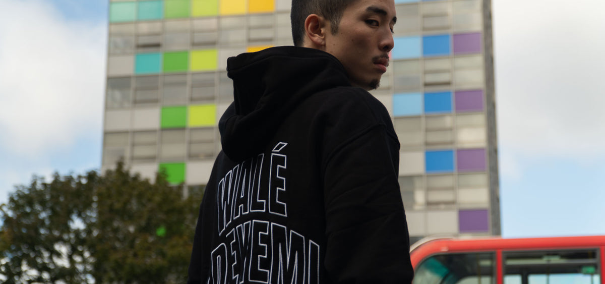 Model wearing a black hoodie with a Wale Adeyemi print on the back, mobile banner