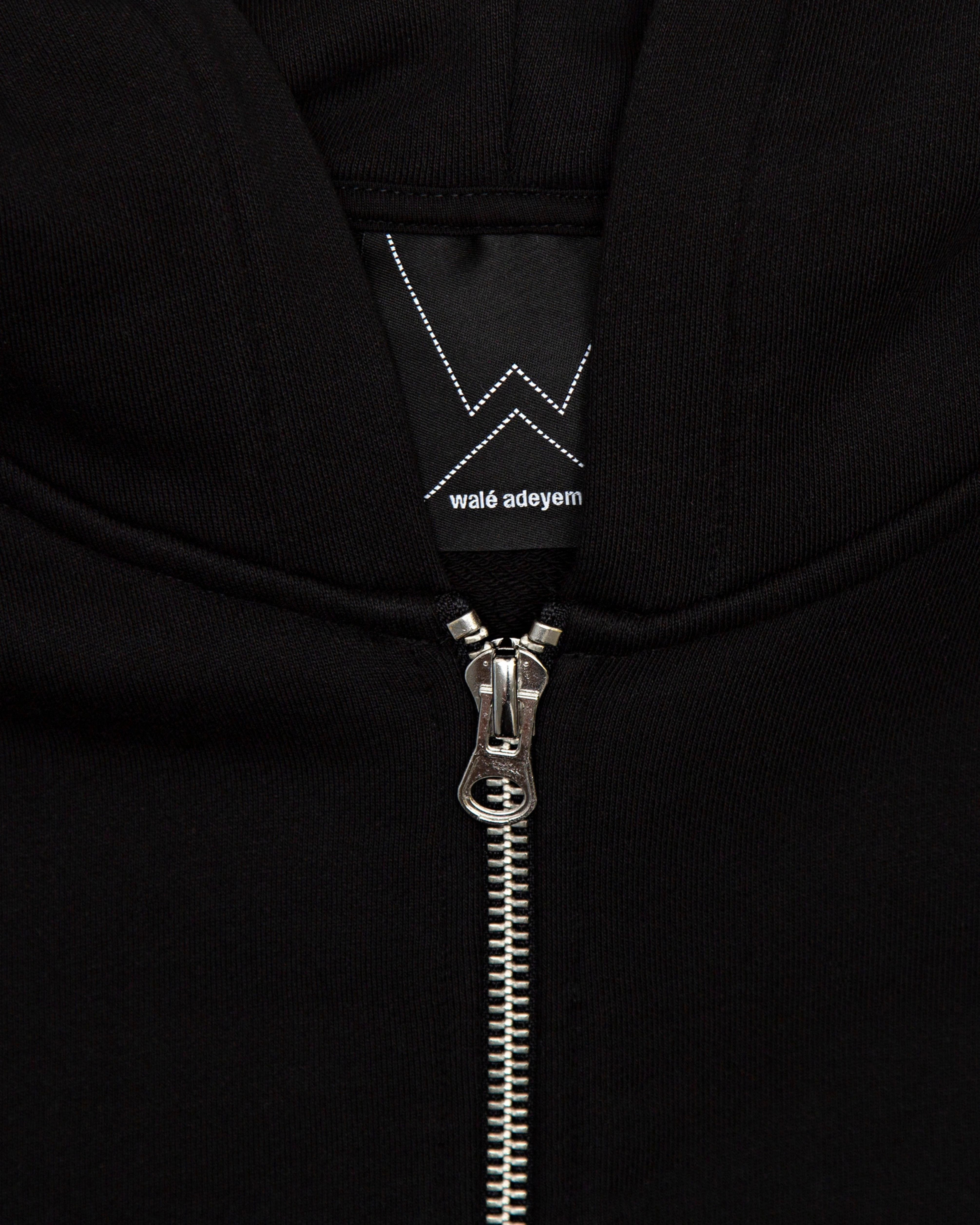 Close-up of the zip label on the Walé Adeyemi Vinnie Hoodie in Black/White