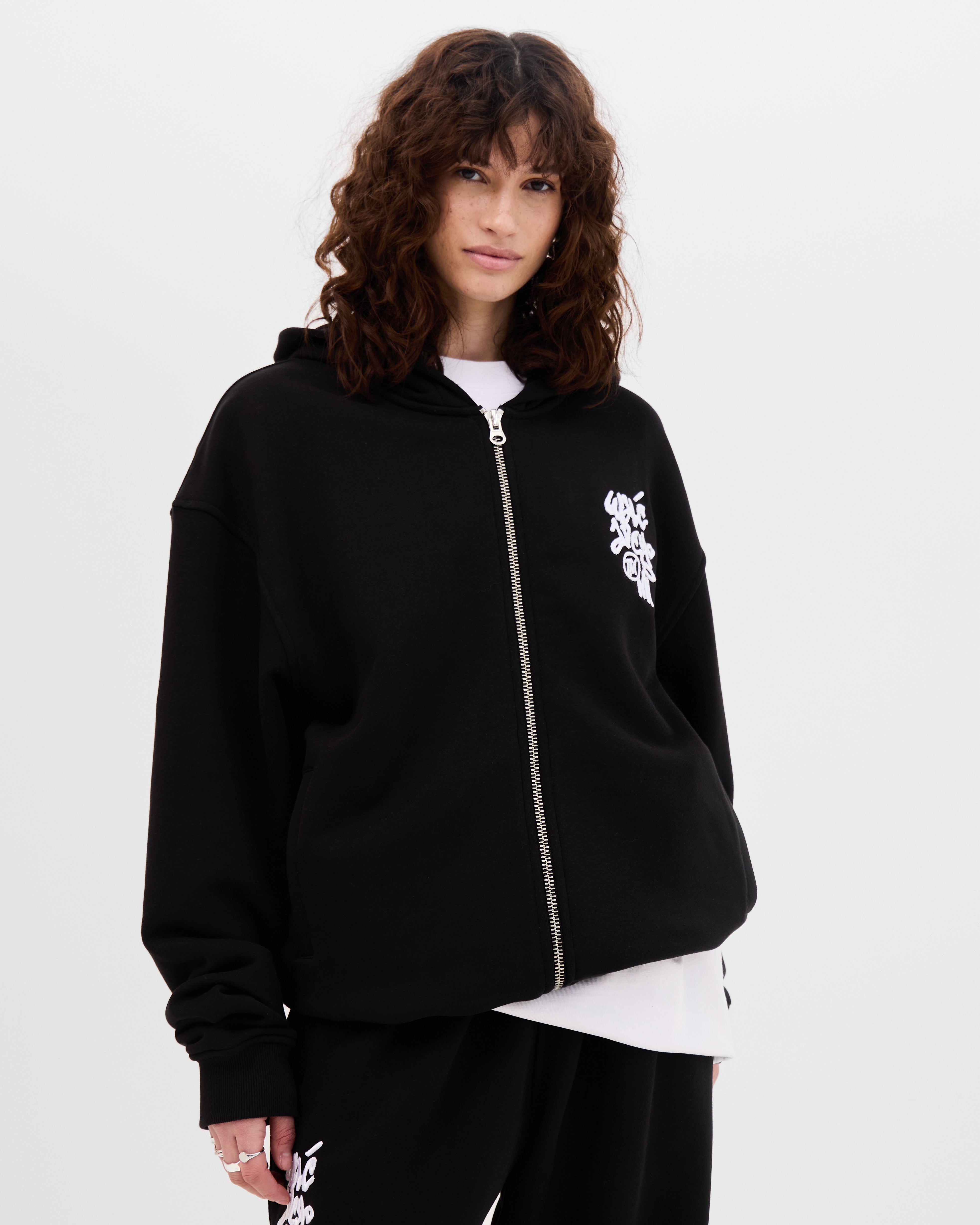 Model wearing the Walé Adeyemi Vinnie full-zip hoodie in Black/White, oversized fit, front view