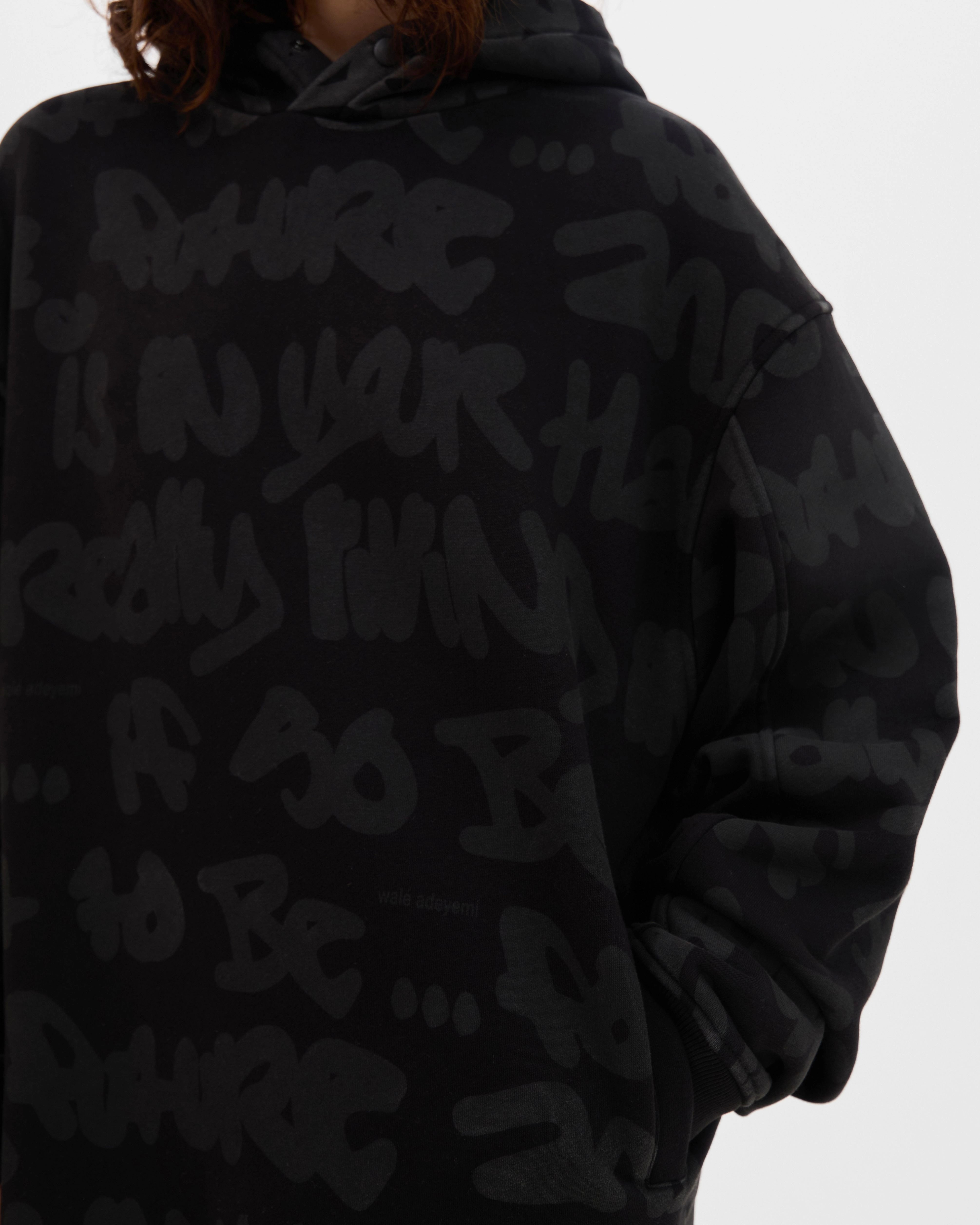 Close-up of the print on the Walé Adeyemi AOP Graf Hood in Black