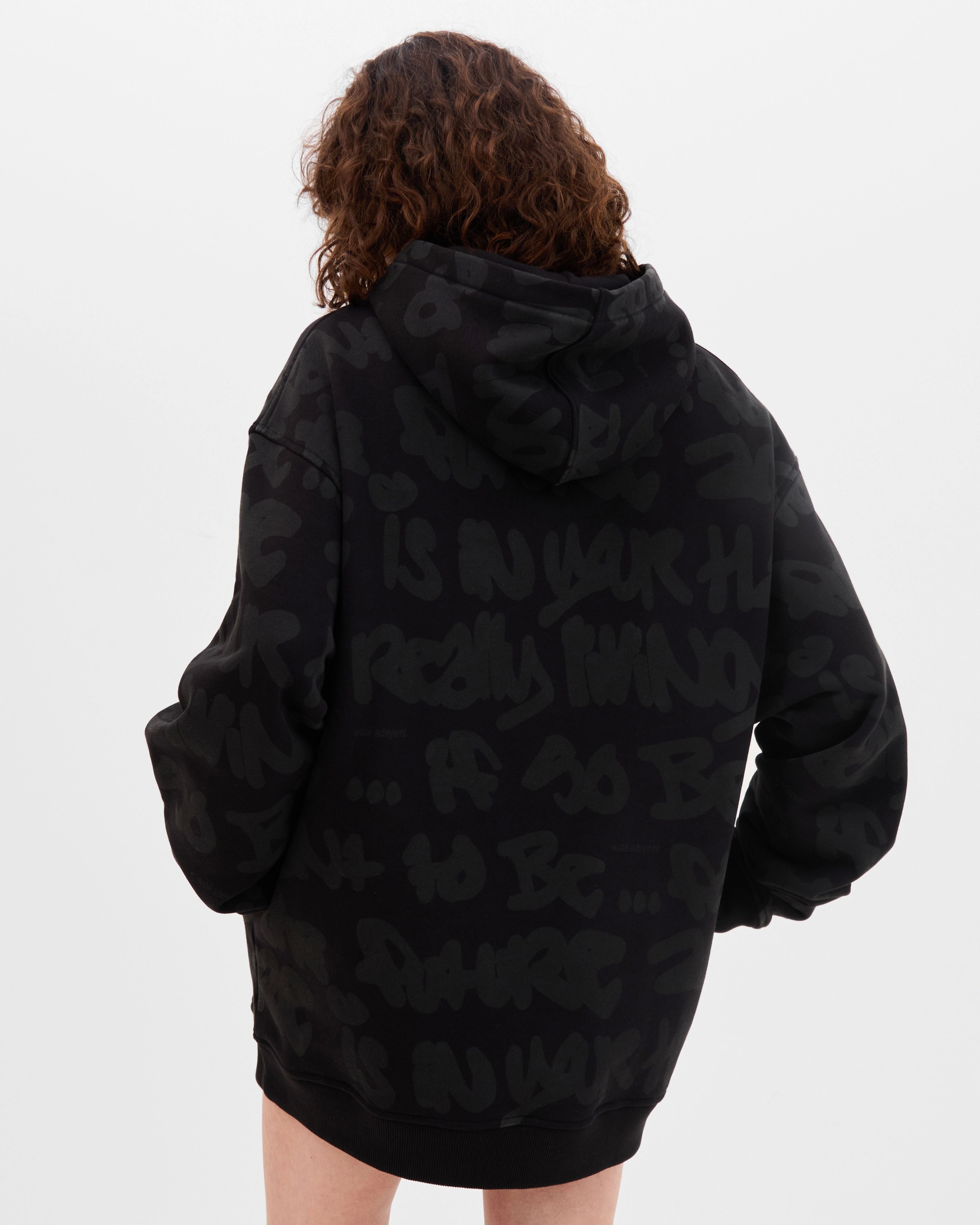 Model wearing the Walé Adeyemi AOP Graf Hood in Black, back view