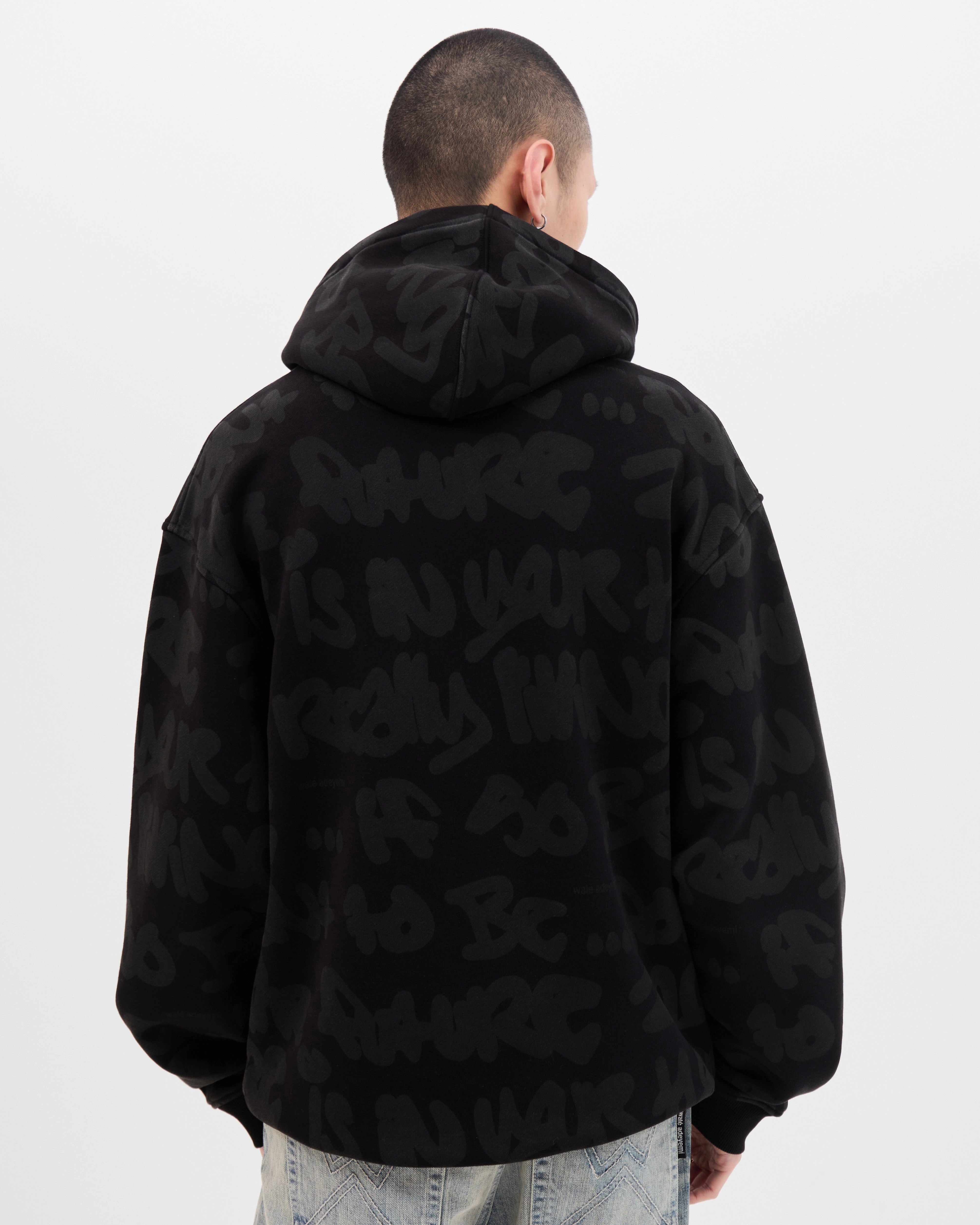 Model wearing the Walé Adeyemi AOP Graf Hood in Black, close back view