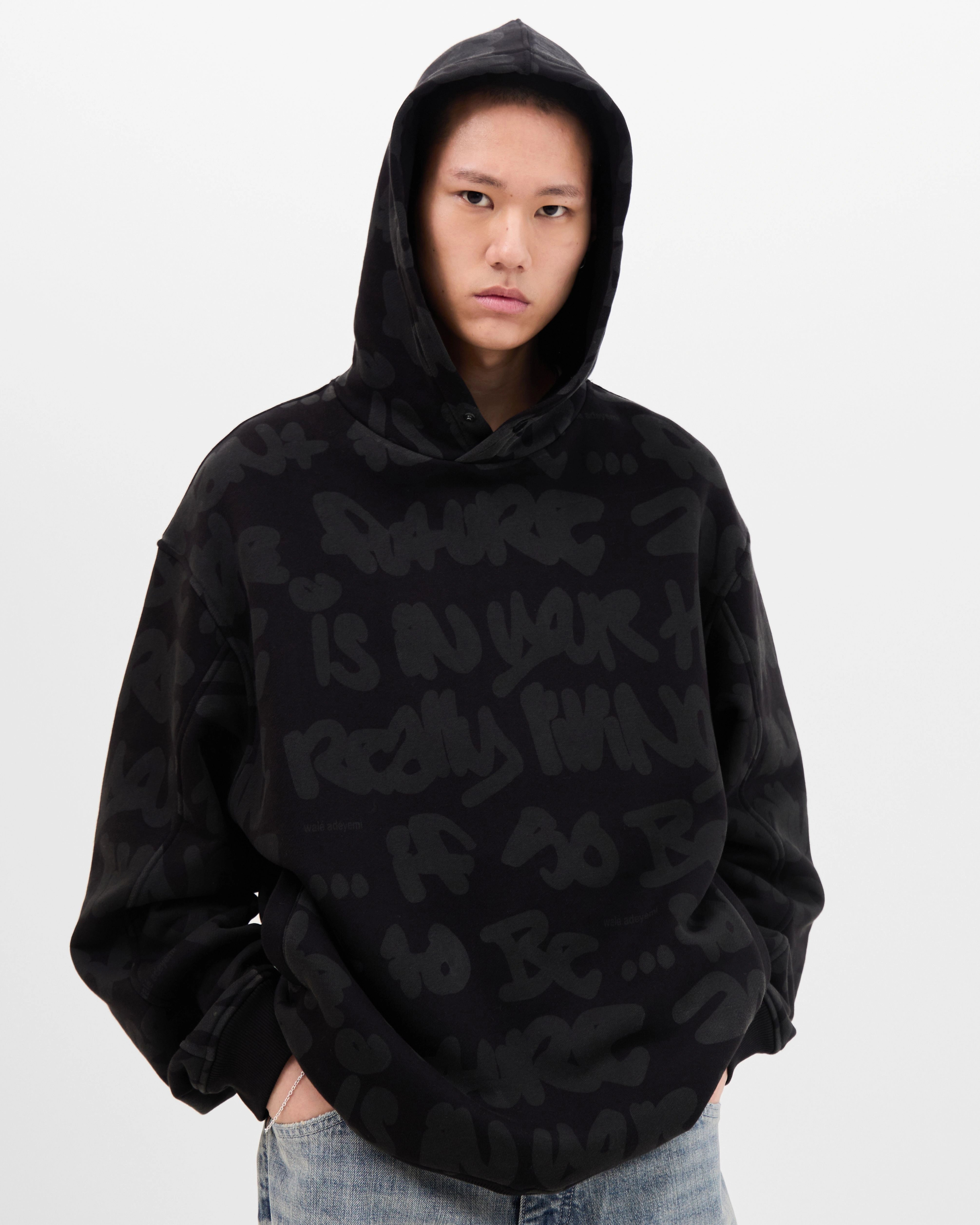 Model wearing the Walé Adeyemi AOP Graf Hood in Black, front view
