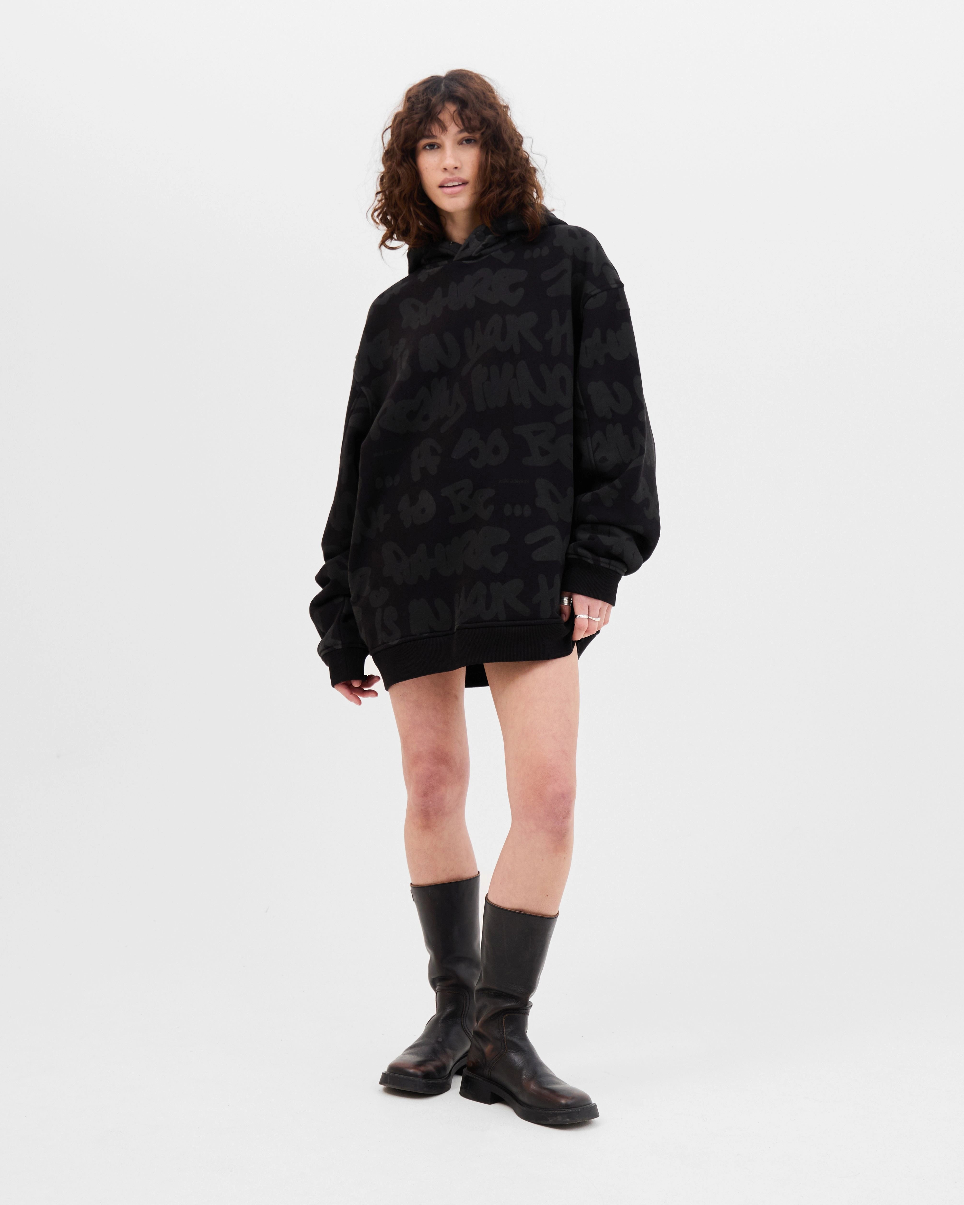 Model wearing the Walé Adeyemi AOP Graf Hood in Black, alternate front view