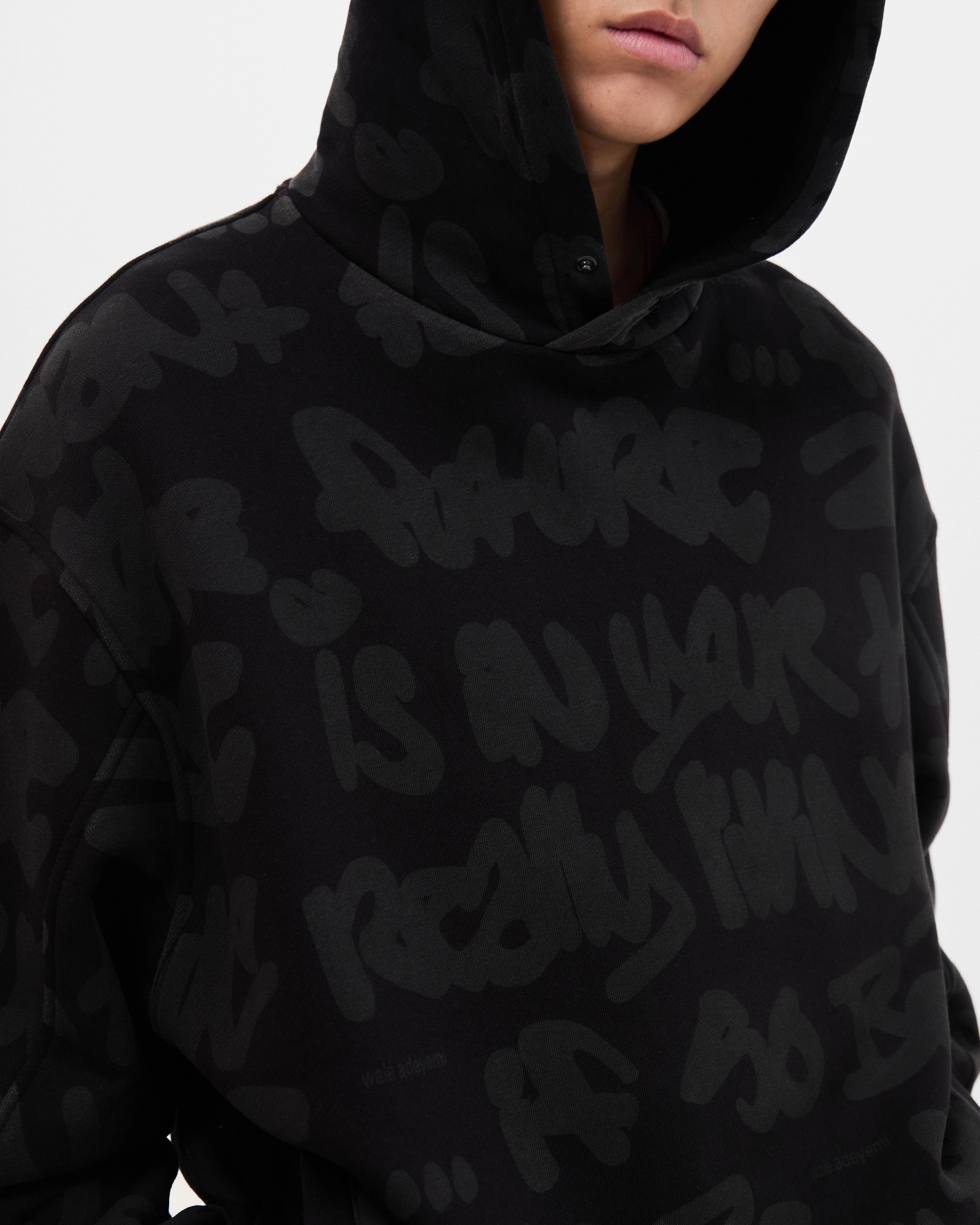 Model wearing the Walé Adeyemi AOP Graf Hood in Black, close front view