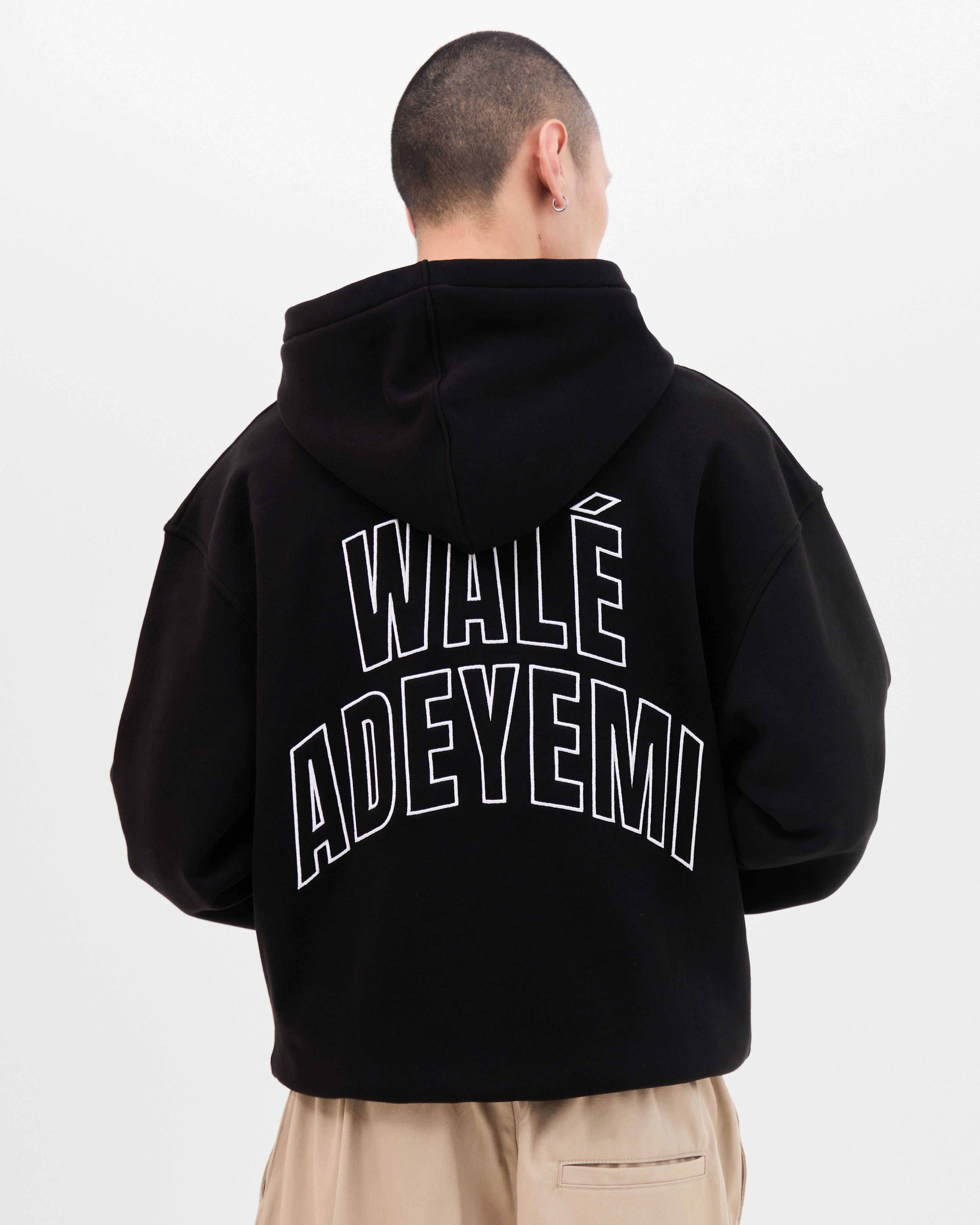 Model wearing the Walé Adeyemi Bridge Hoodie in Black/White, full back view