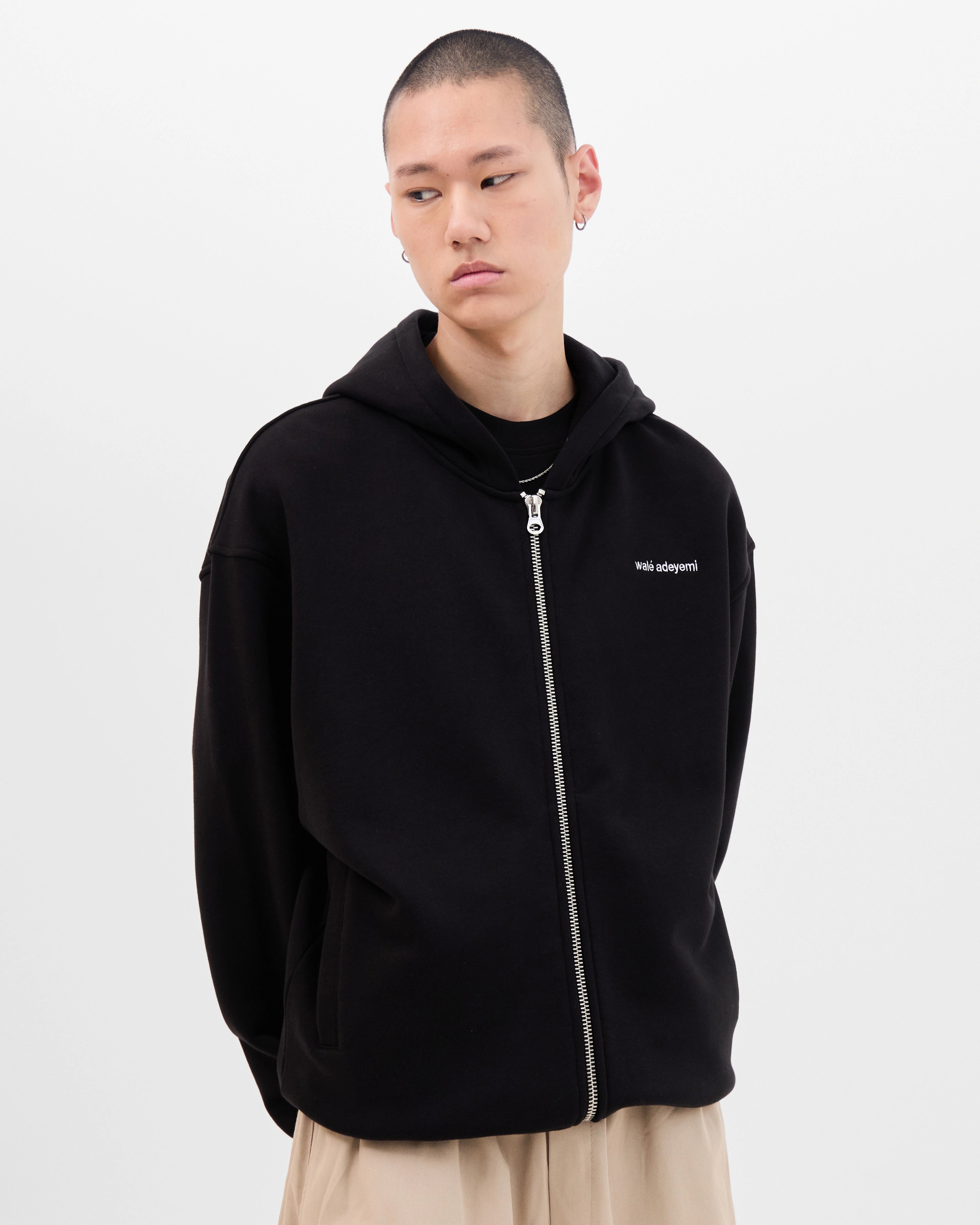Model wearing the Walé Adeyemi Bridge Hoodie in Black/White, front view