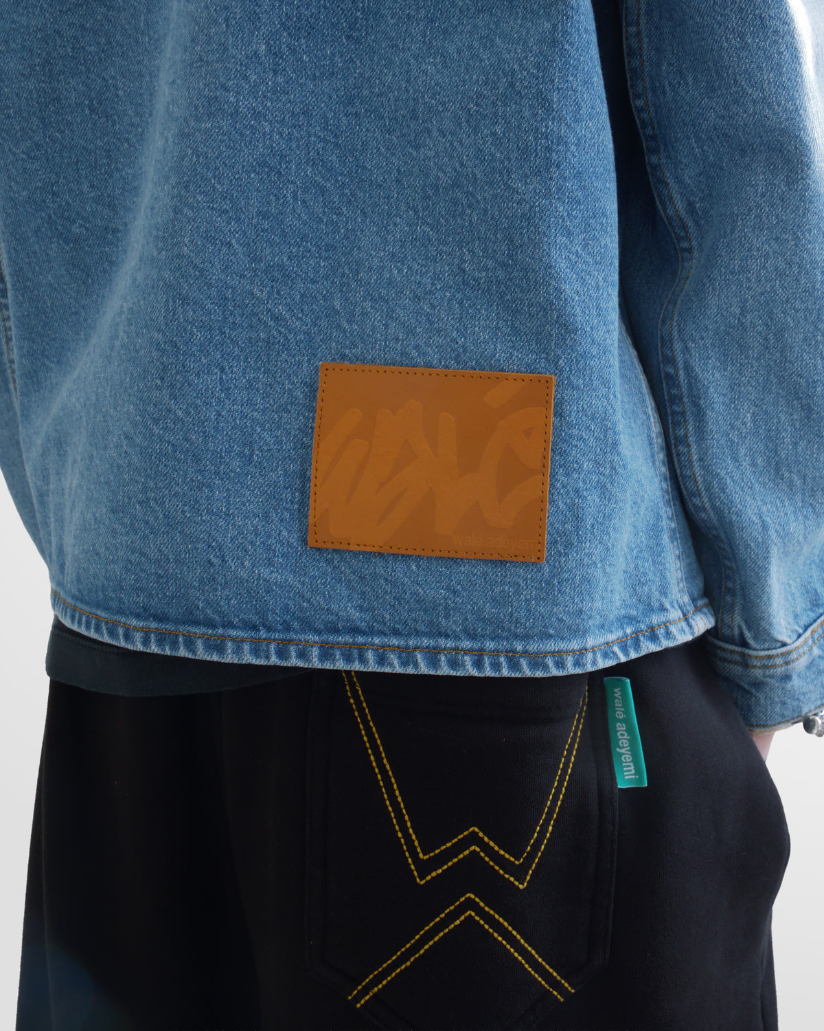 Walé Adeyemi Studio Denim Overshirt in Blue (light blue wash), on model, hem patch detail