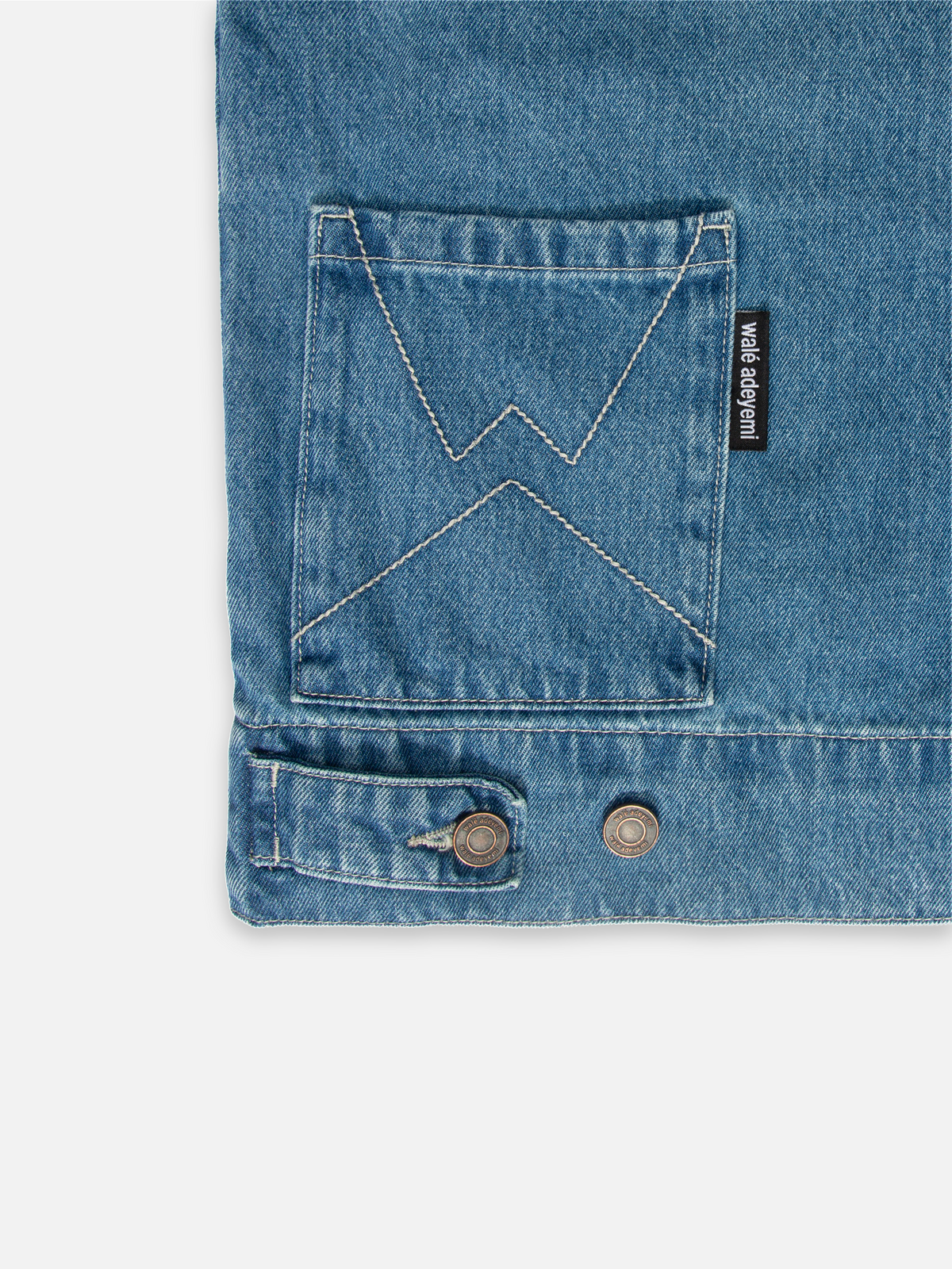 Close-up of the front pocket on Walé Adeyemi Phantom Denim Jacket in Faded