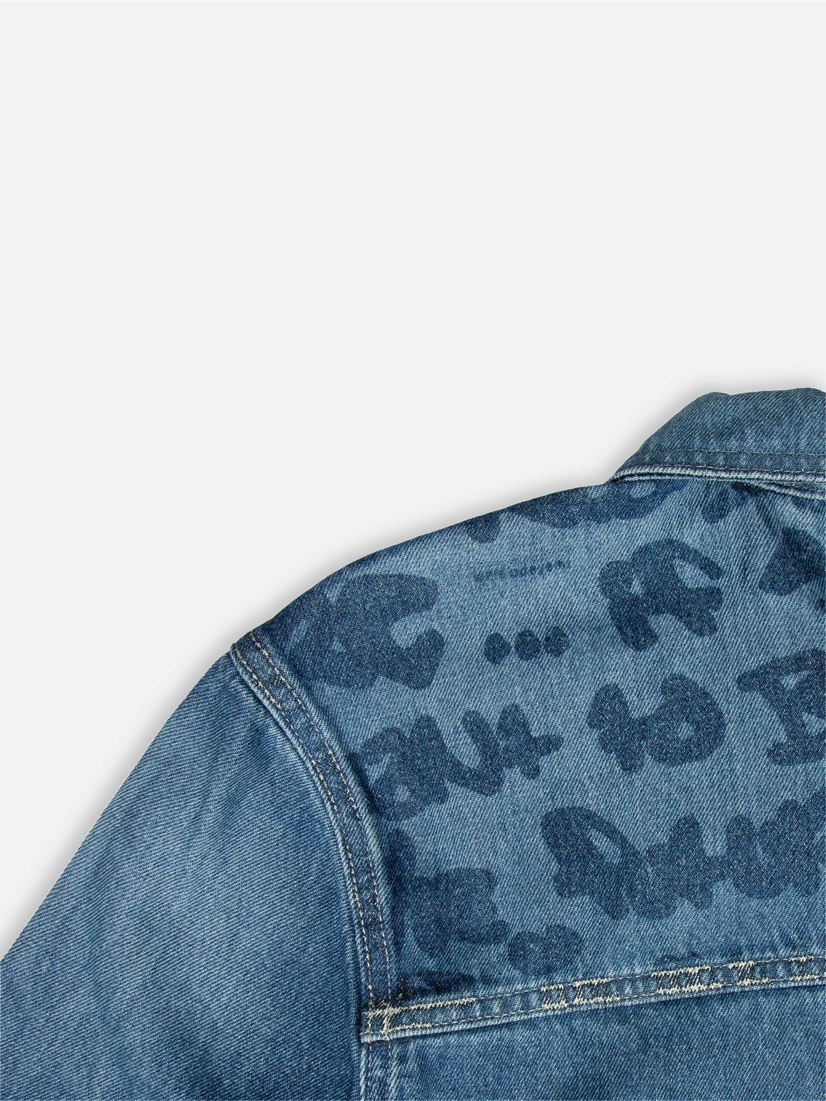 Close-up of the lasered Graf on the back yoke of Walé Adeyemi Phantom Denim Jacket in Ink