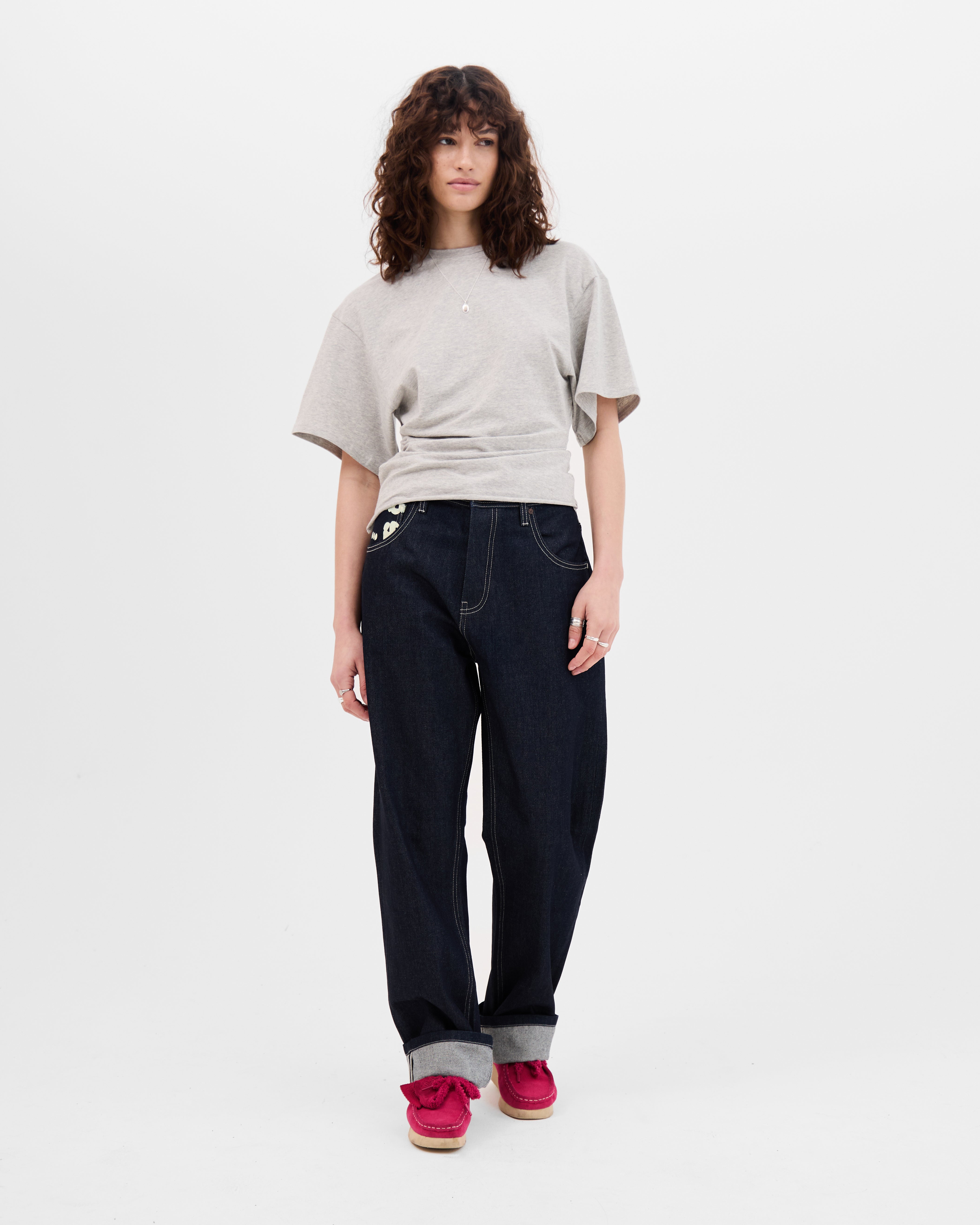 Model wearing the Walé Adeyemi Archive Graf Denim Jeans in Navy/Lemon with turned-up hems, full-length front view