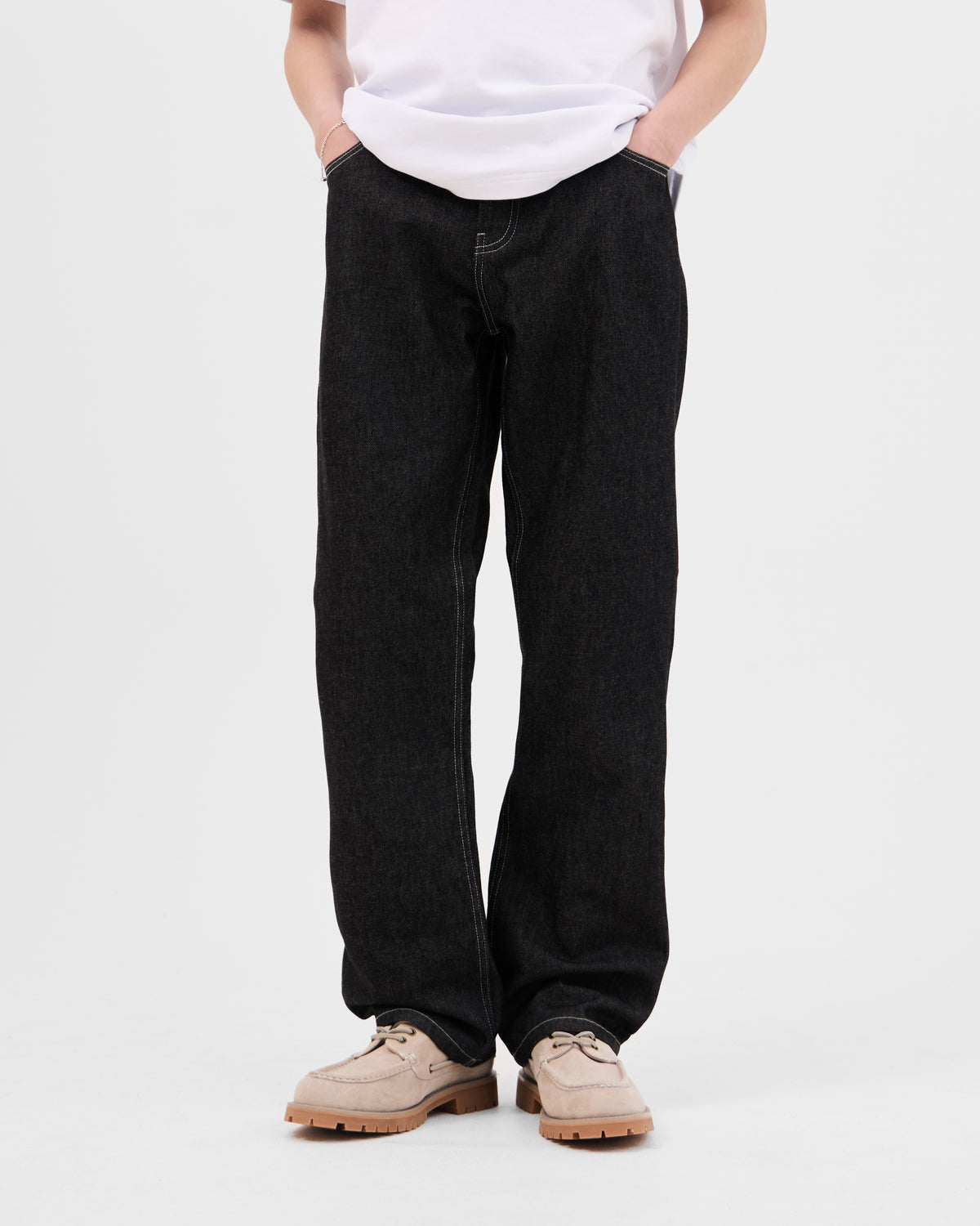 Model wearing the Walé Adeyemi Midnight Graf Denim Jeans in Black, relaxed straight fit, front view