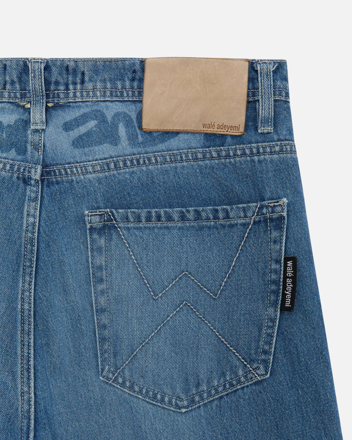 Close-up of the back pocket on Walé Adeyemi Phantom Denim Jeans in Faded