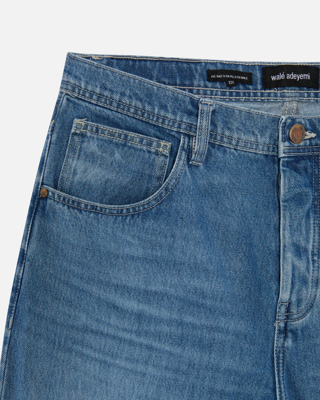 Close-up of the front pocket on Walé Adeyemi Phantom Denim Jeans in Faded