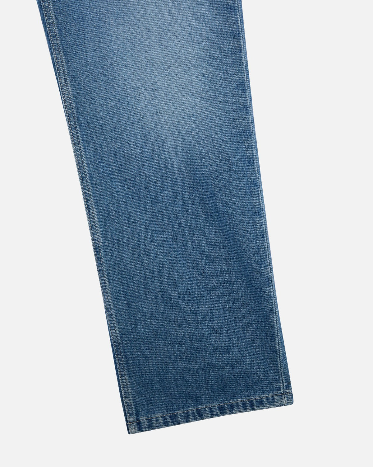 Close-up of the hem on Walé Adeyemi Phantom Denim Jeans in Faded