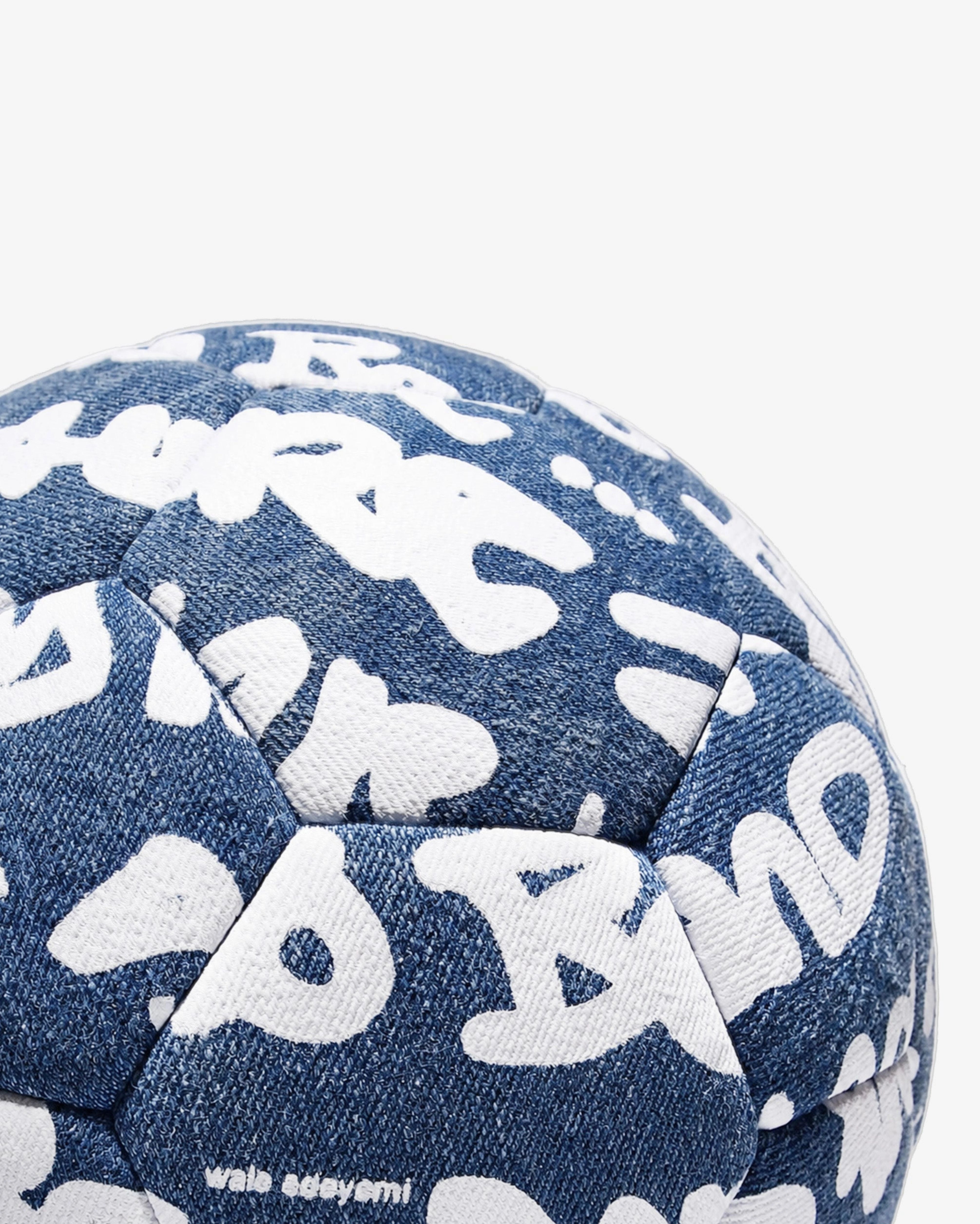 Close-up detail of the Walé Adeyemi Trivela Denim Football in Denim/White