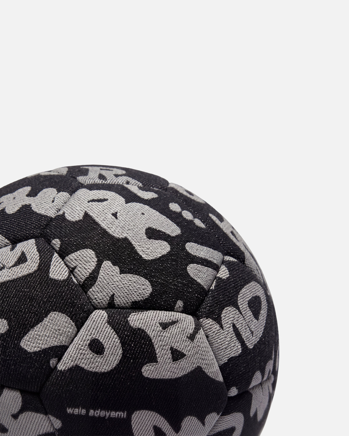 Close-up of the Walé Adeyemi Trivela Denim Football in Black, grey Graf across the panels