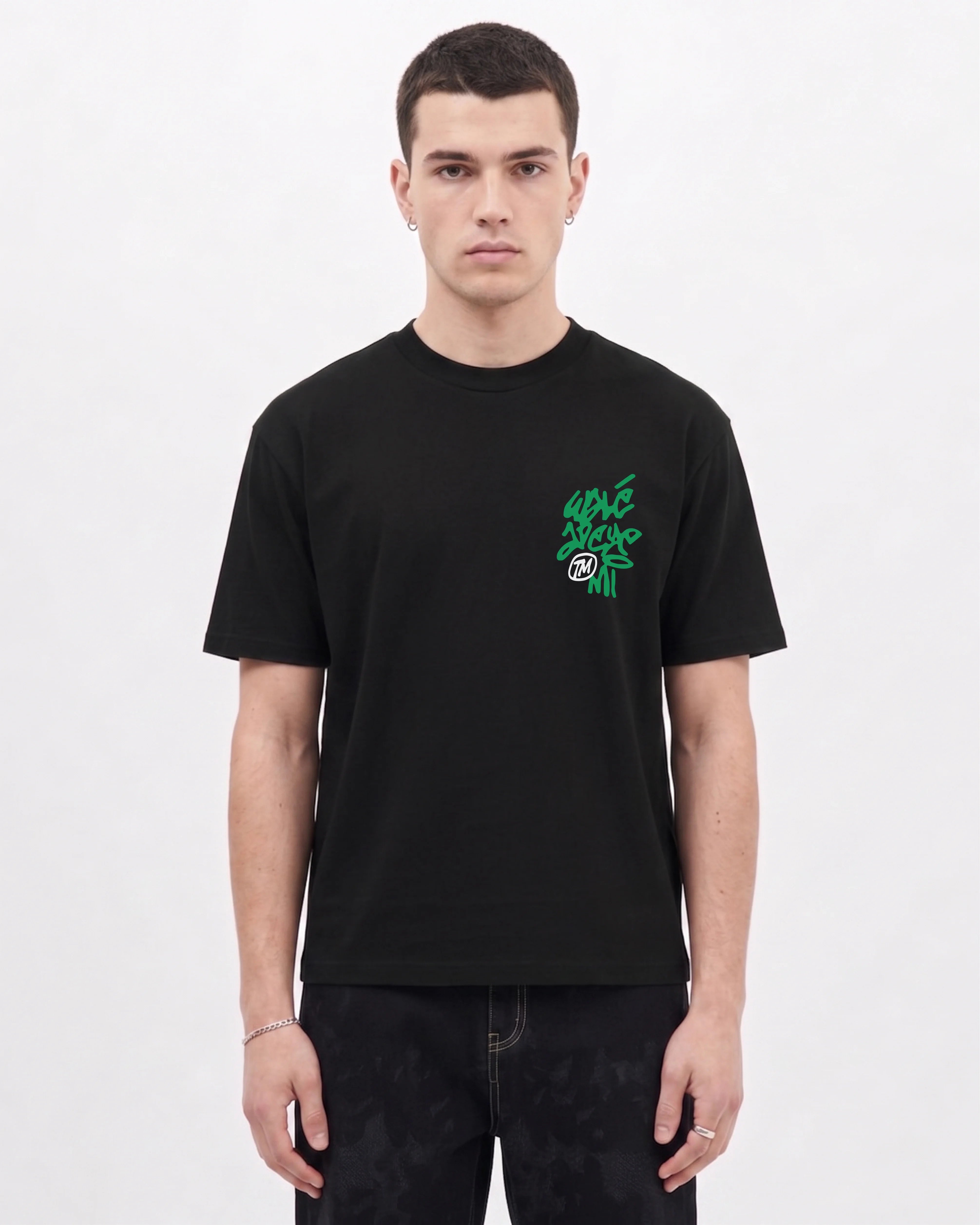 Model wearing the Walé Adeyemi Vinnie T-shirt in Black/Green, front view
