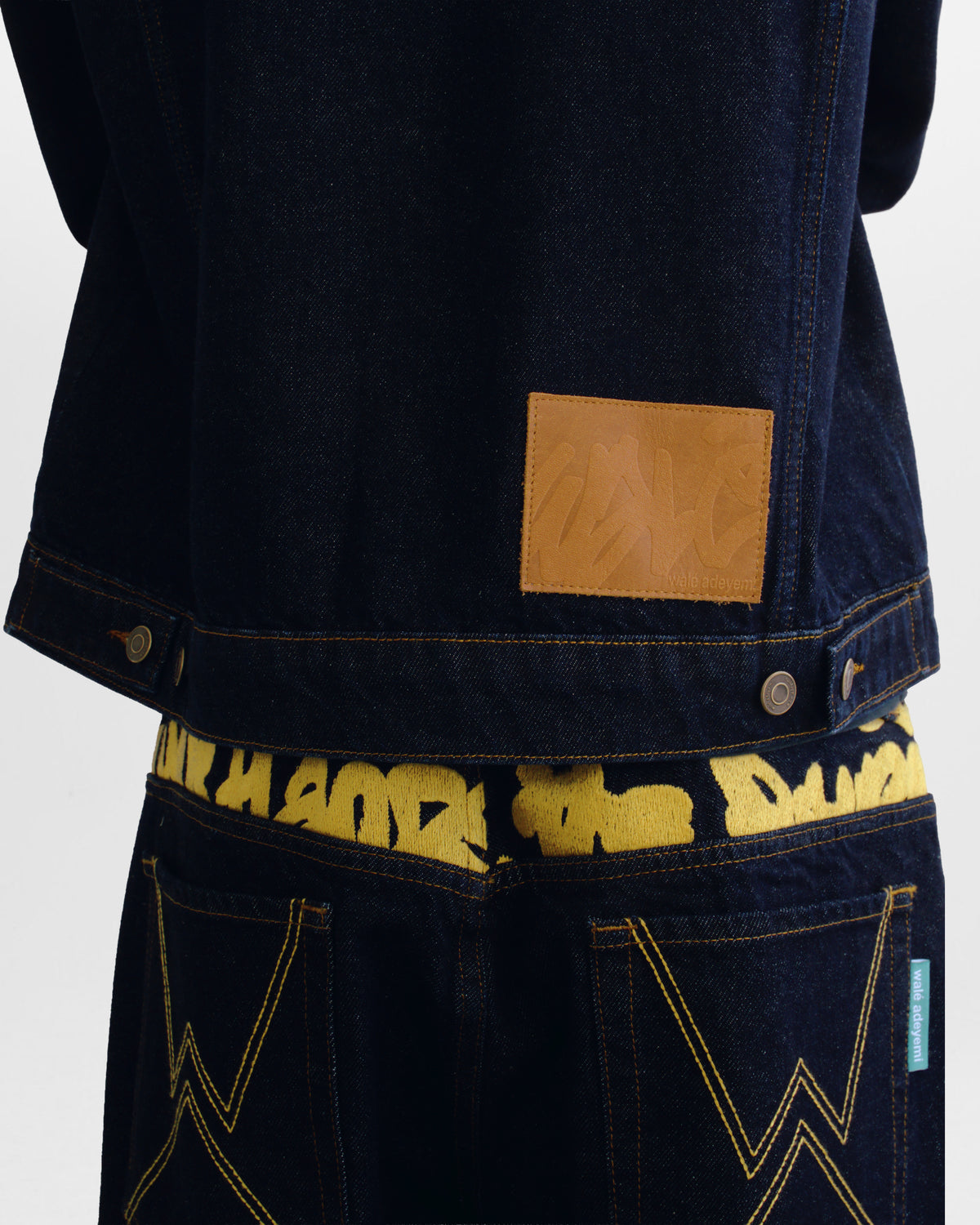 Walé Adeyemi Sessions Denim Jeans in Misted Yellow (raw rinse wash), on model, embroidered waistband graphic detail