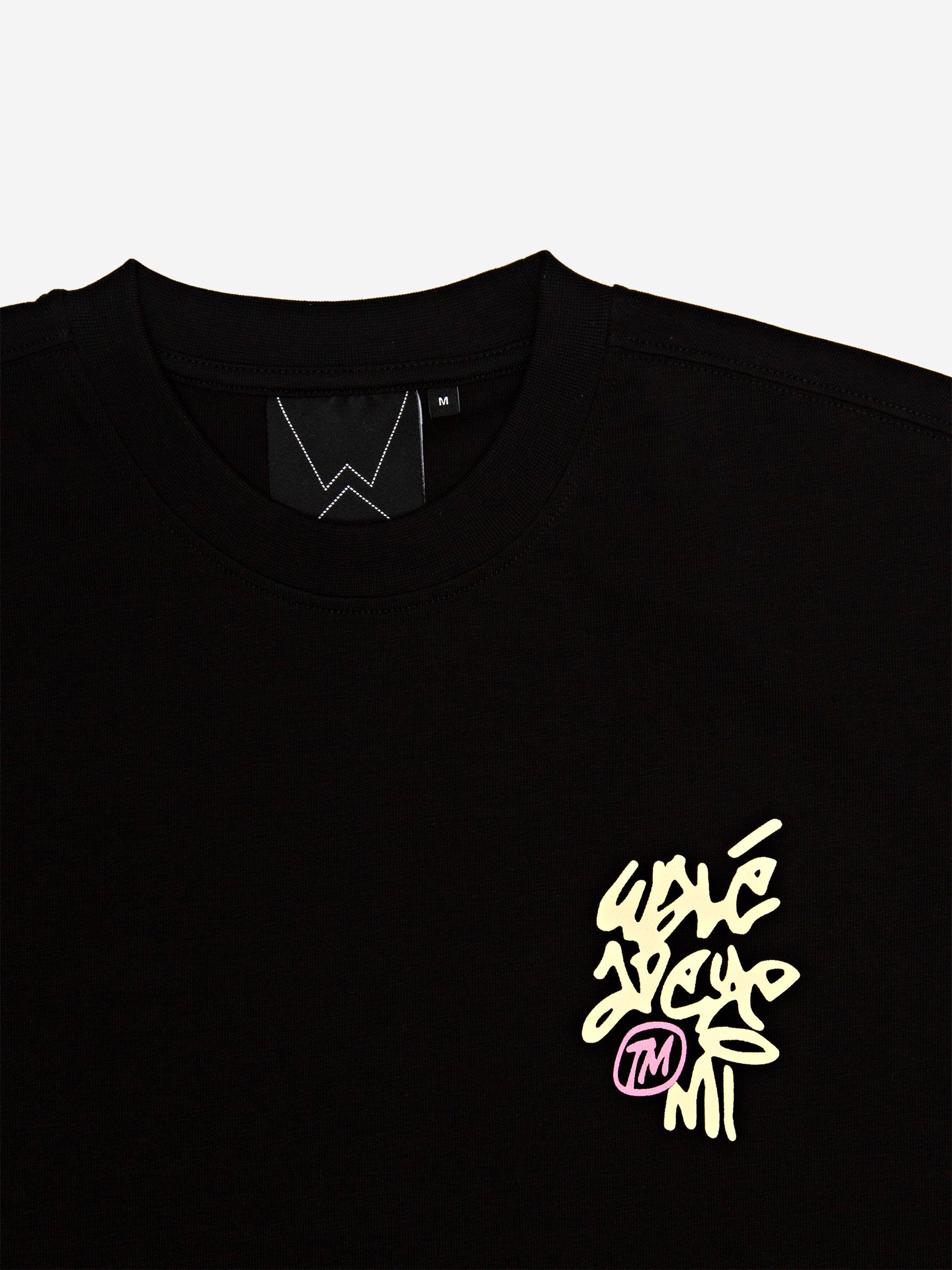 Close-up of the Walé Adeyemi neck label and chest logo on the Vinnie T-shirt in Black/Lemon