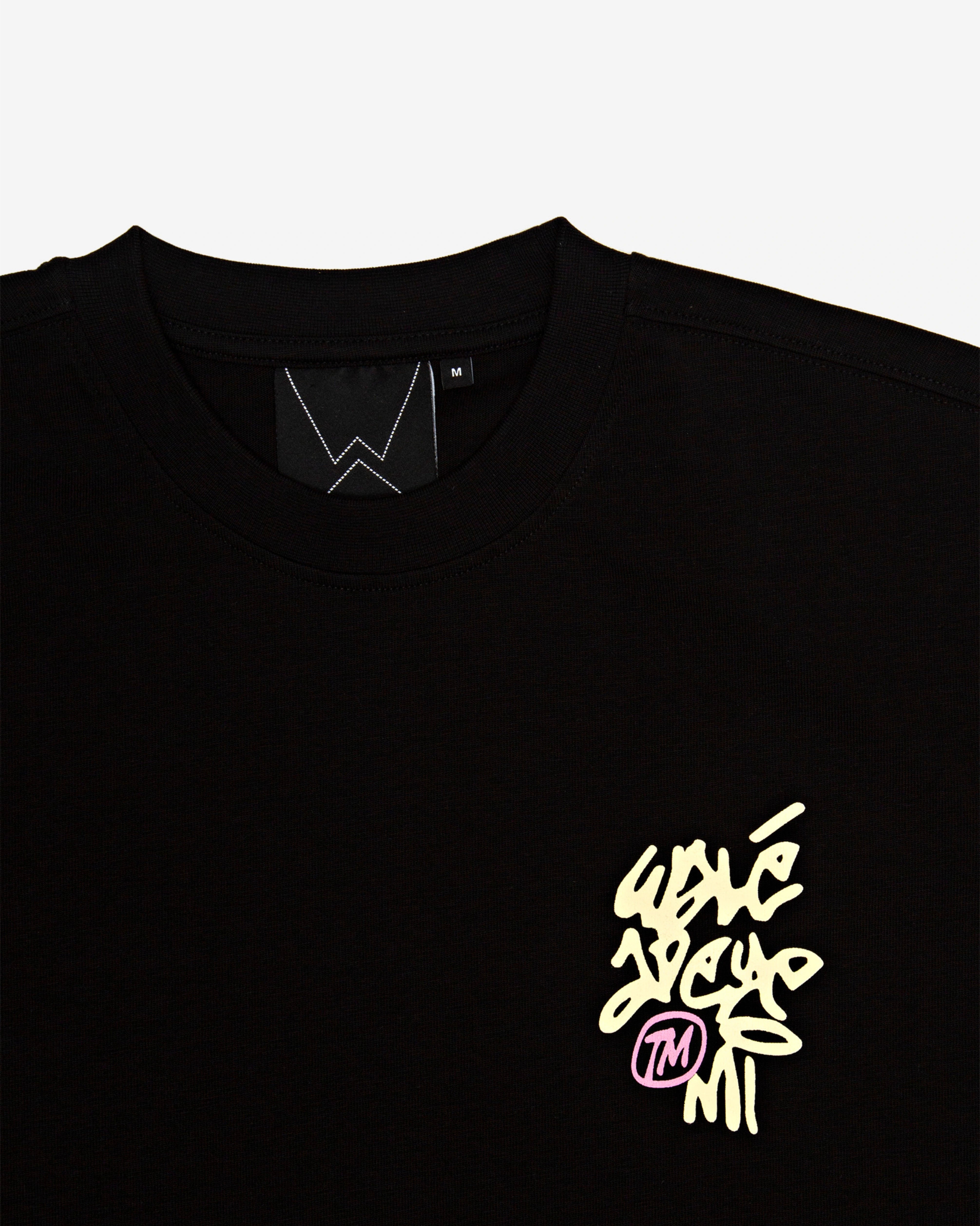 Close-up of the label on the Walé Adeyemi Vinnie T-shirt in Black/Lemon
