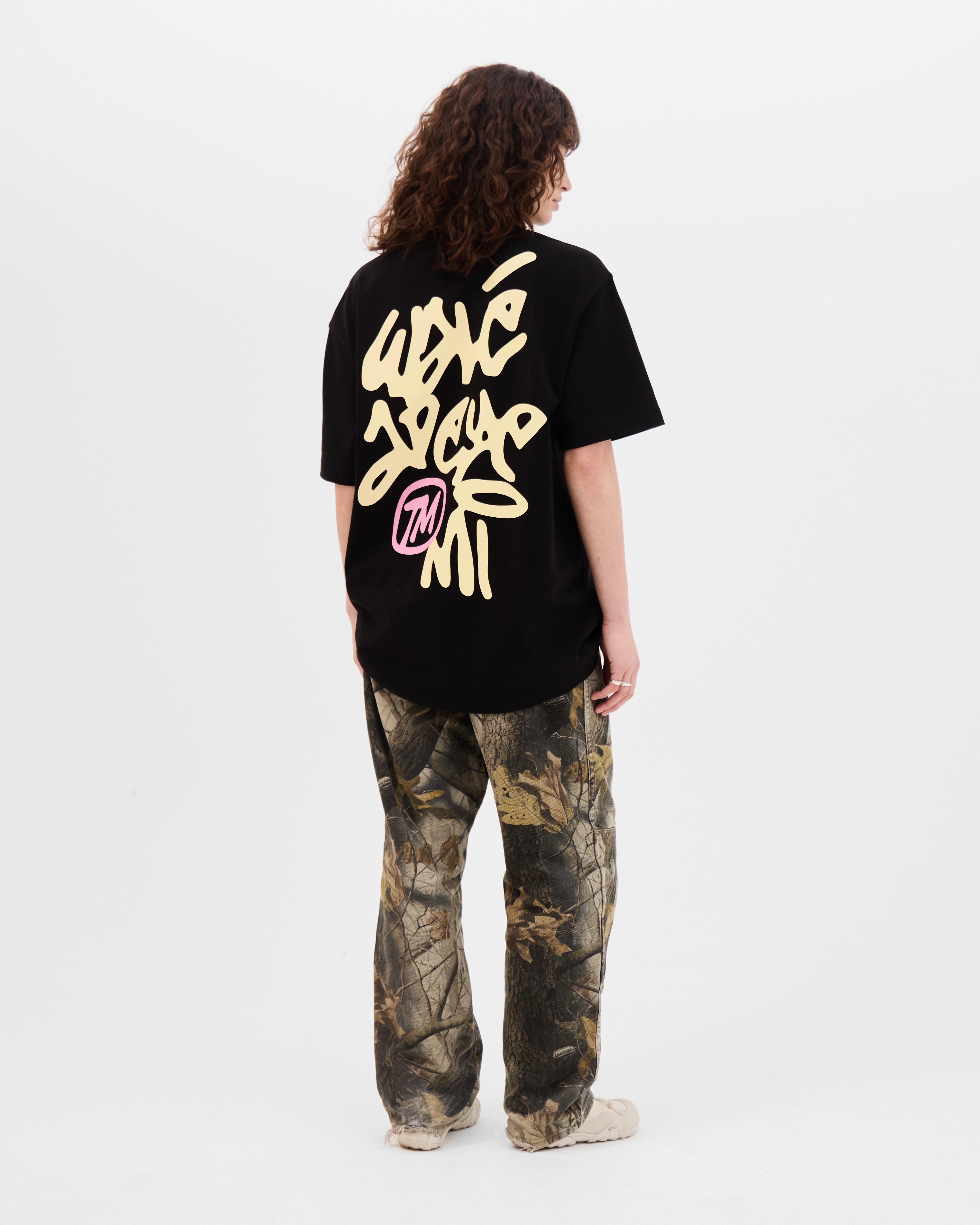 Model wearing the Walé Adeyemi Vinnie T-shirt in Black/Lemon, back view