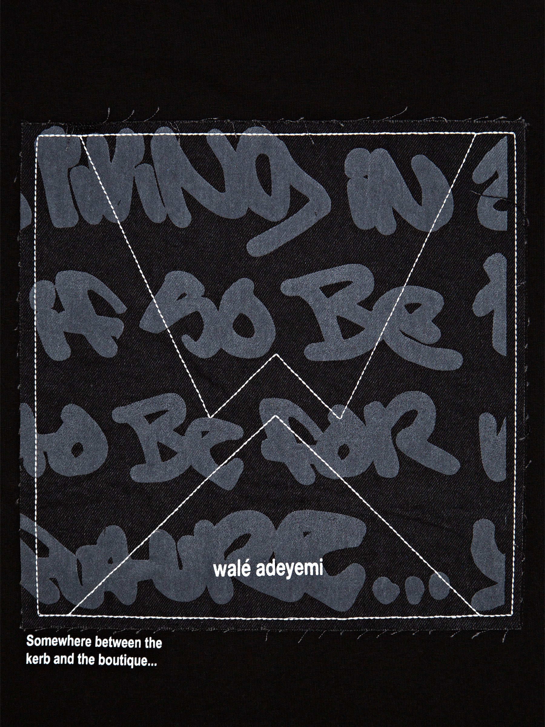 Detail of the graffiti-print denim applique back panel with 'Somewhere between the kerb and the boutique' print, Walé Adeyemi Backbeat T-shirt