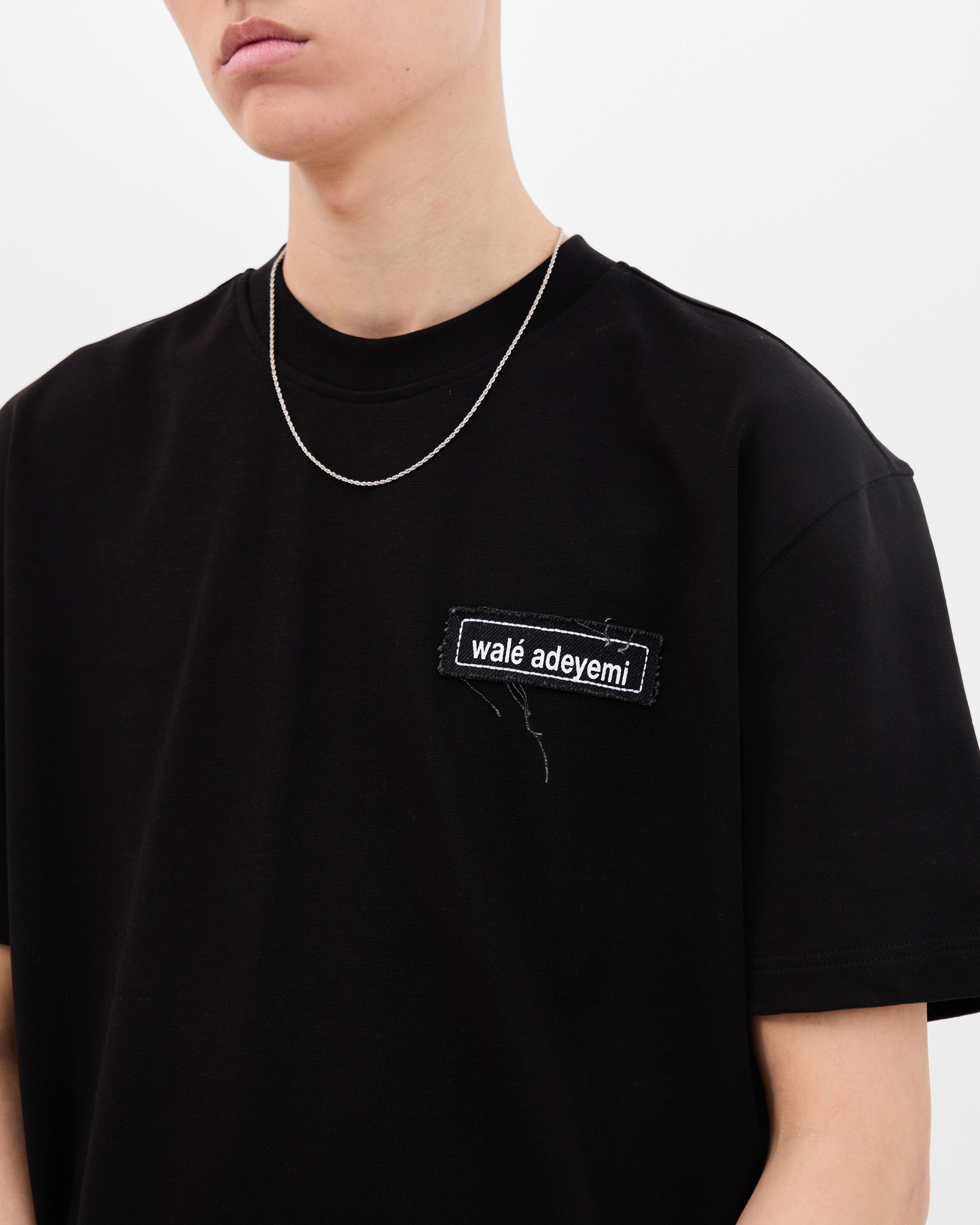 Close-up of the chest patch on the Walé Adeyemi Backbeat T-shirt in Black/White