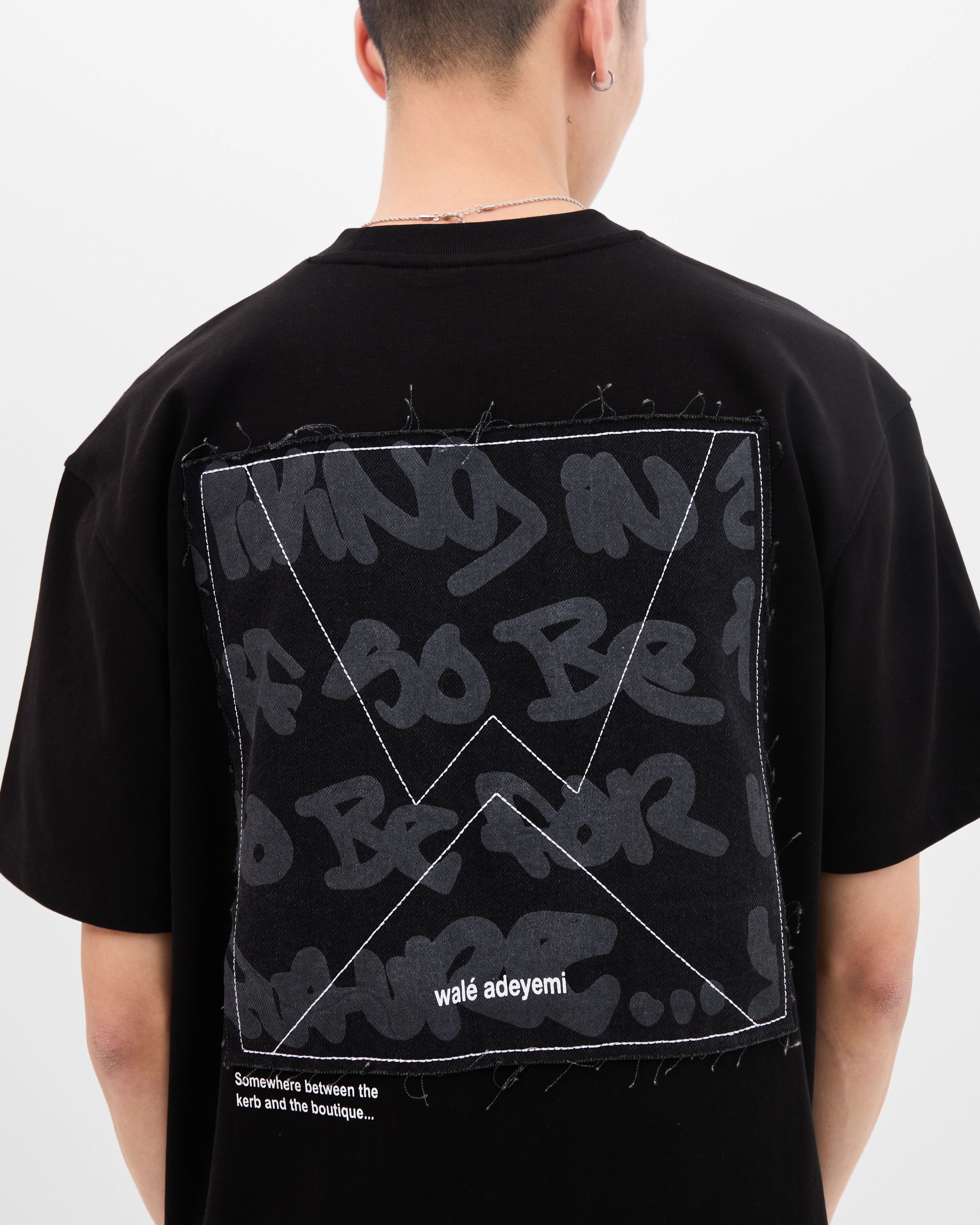 Model wearing the Walé Adeyemi Backbeat T-shirt in Black/White, close back view