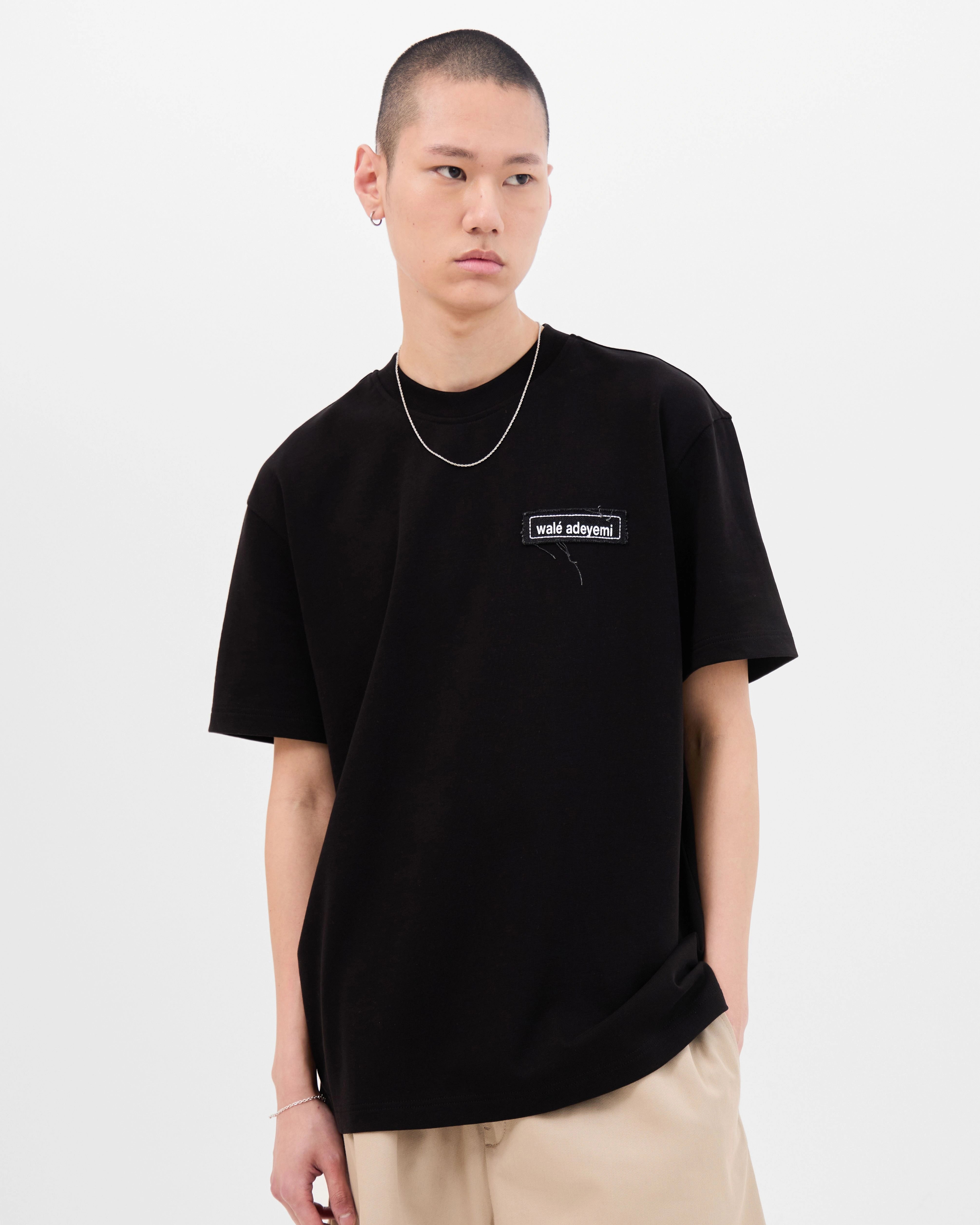 Model wearing the Walé Adeyemi Backbeat T-shirt in Black/White, front view