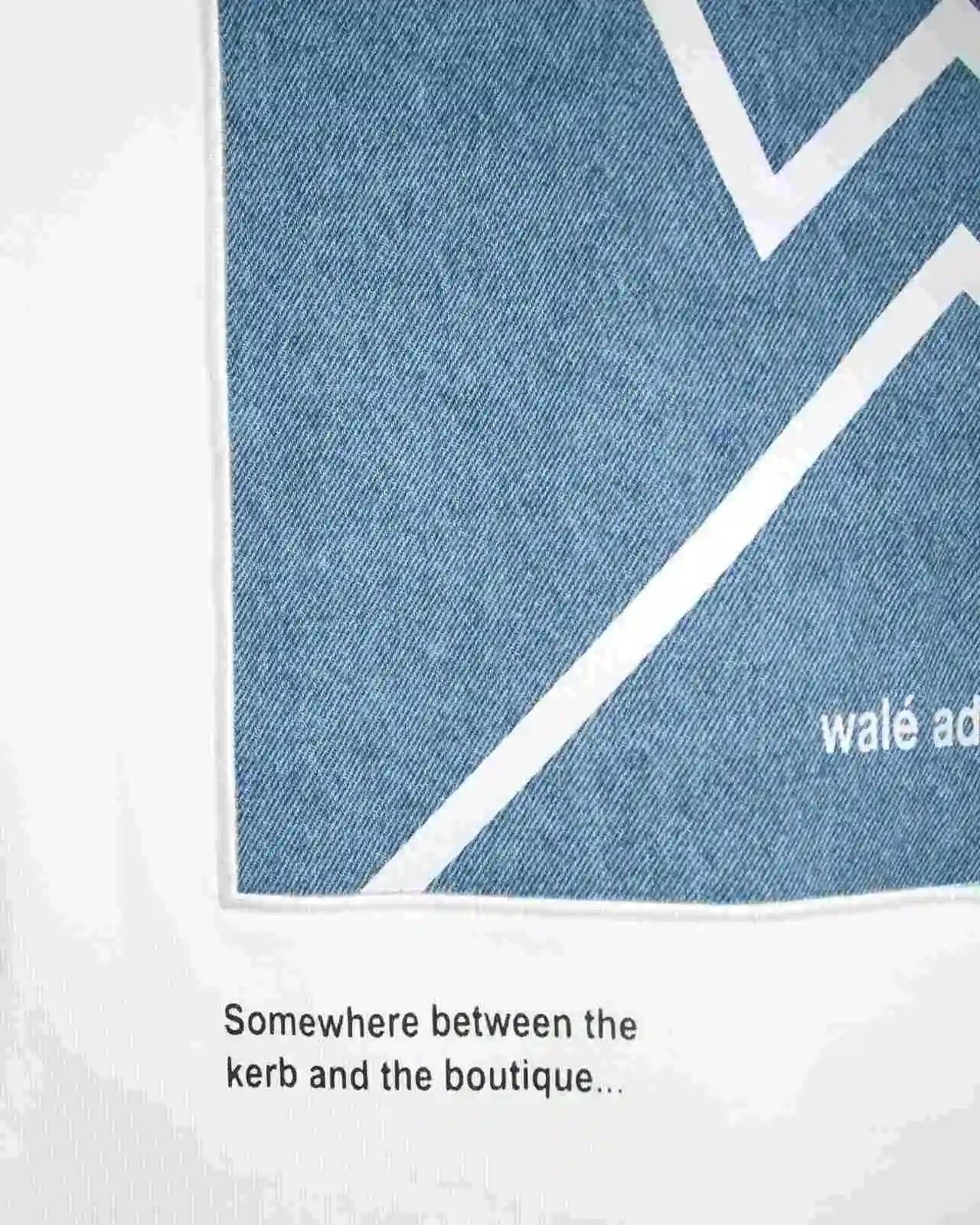 Close-up of the patch text on the Walé Adeyemi Backbeat long-sleeve T-shirt in White/Blue