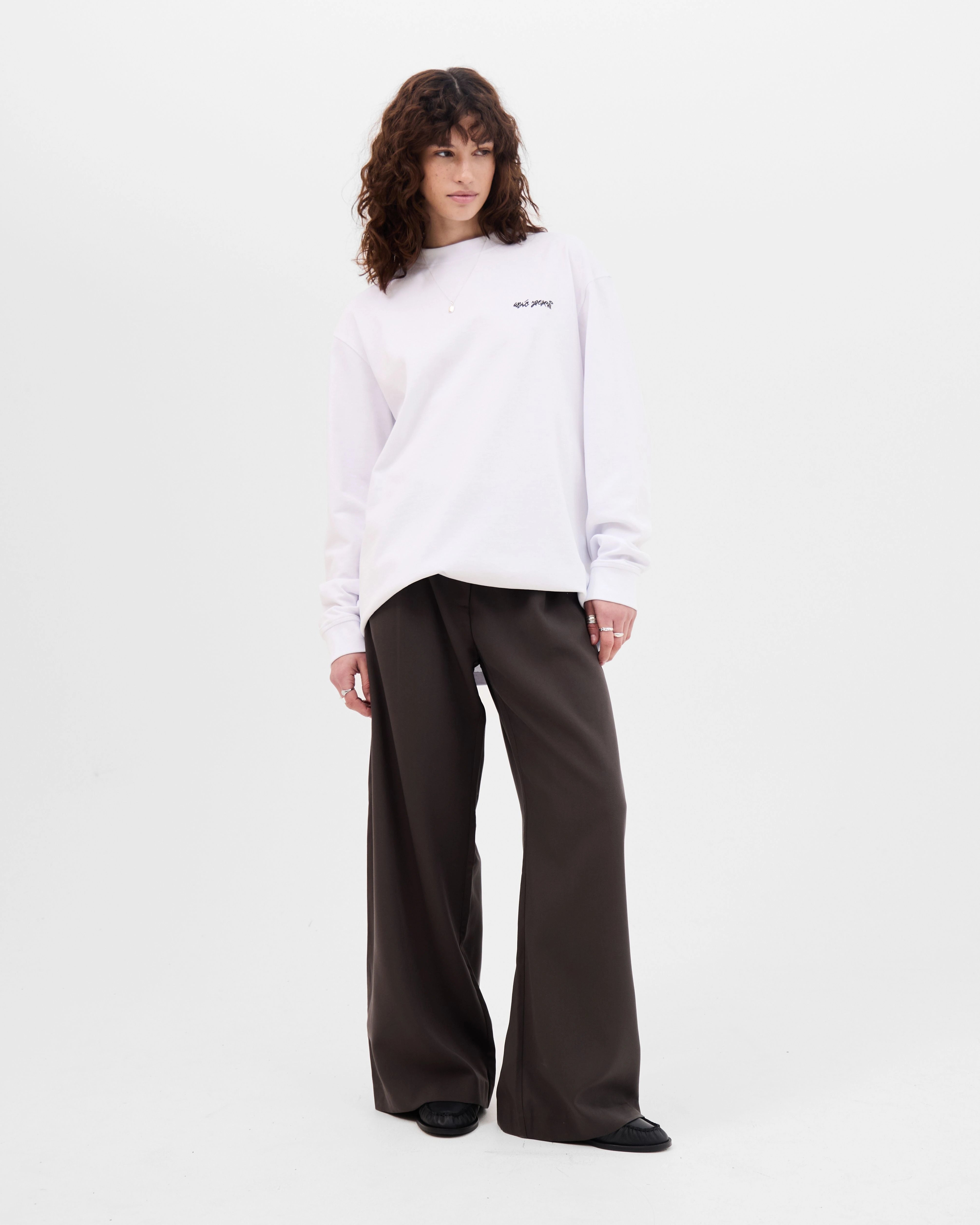 Model wearing the Walé Adeyemi Backbeat long-sleeve T-shirt in White/Blue, alternate front view