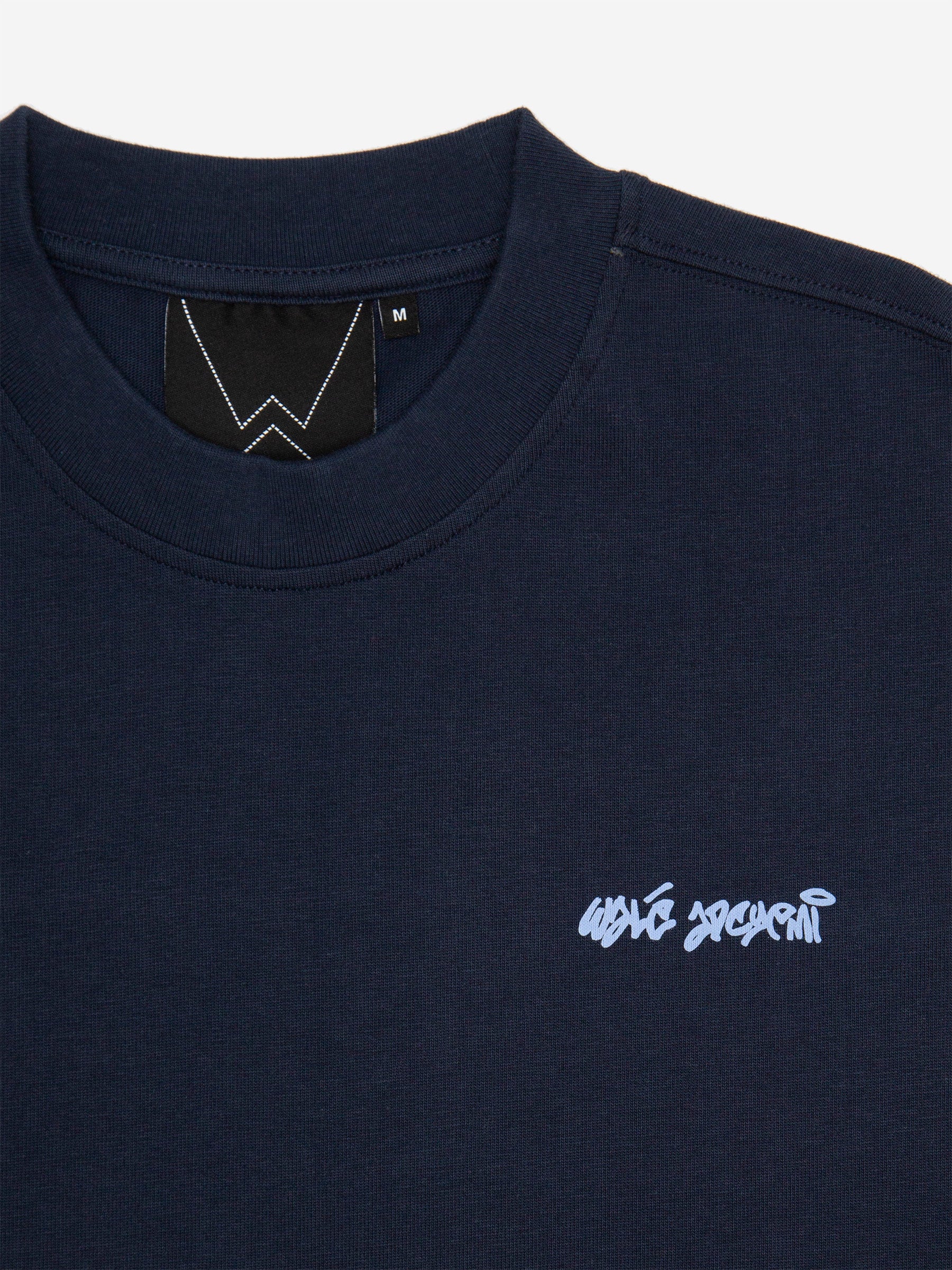 Close-up of the neck label and chest logo on the Walé Adeyemi Column T-shirt in Blue/Light Blue