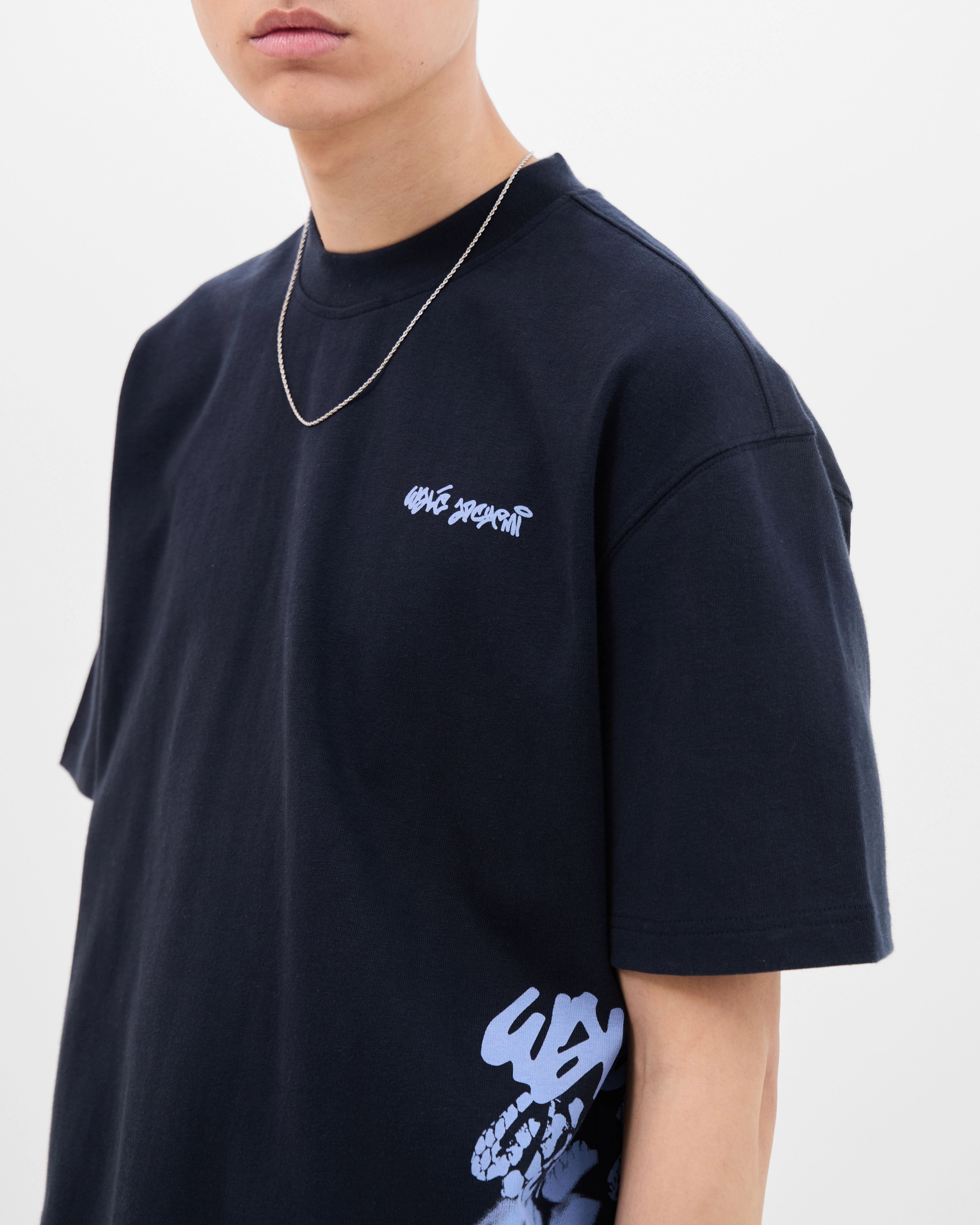 Model wearing the Walé Adeyemi Column T-shirt in Blue/Light Blue, close front view