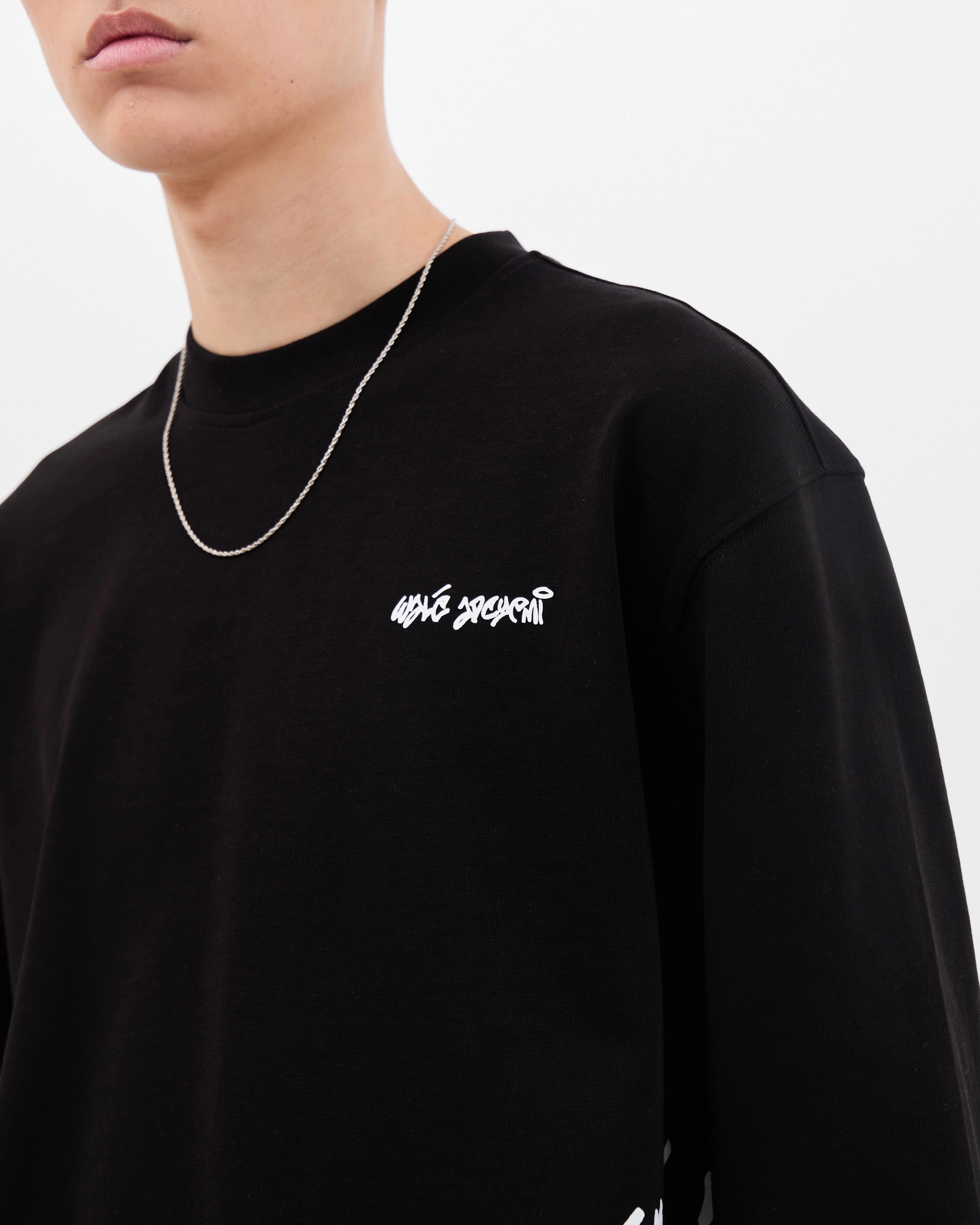 Model wearing the Walé Adeyemi Column long-sleeve T-shirt in Black/White, close front view