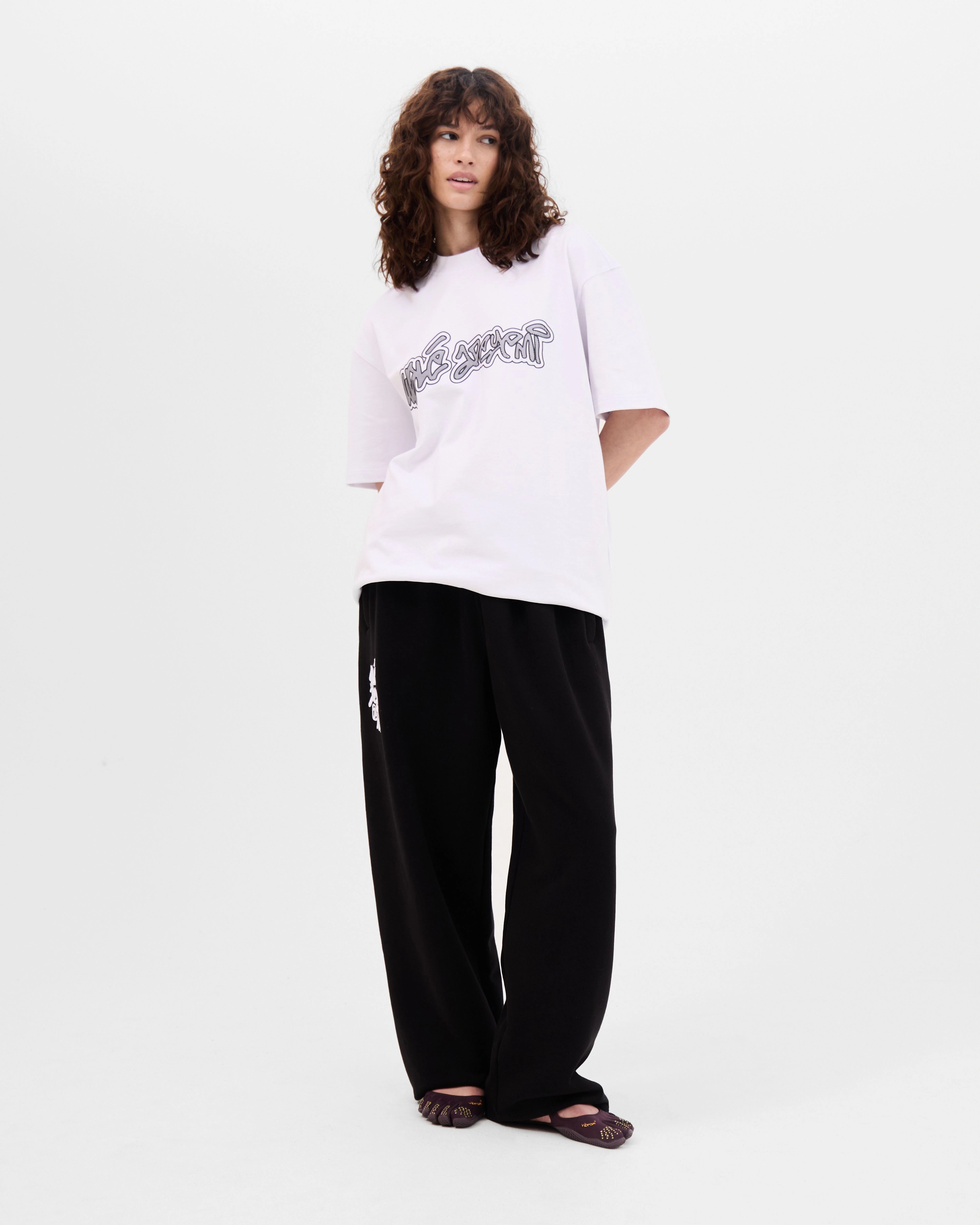 Model wearing the Walé Adeyemi Rhythm T-shirt in White/Black, alternate front view