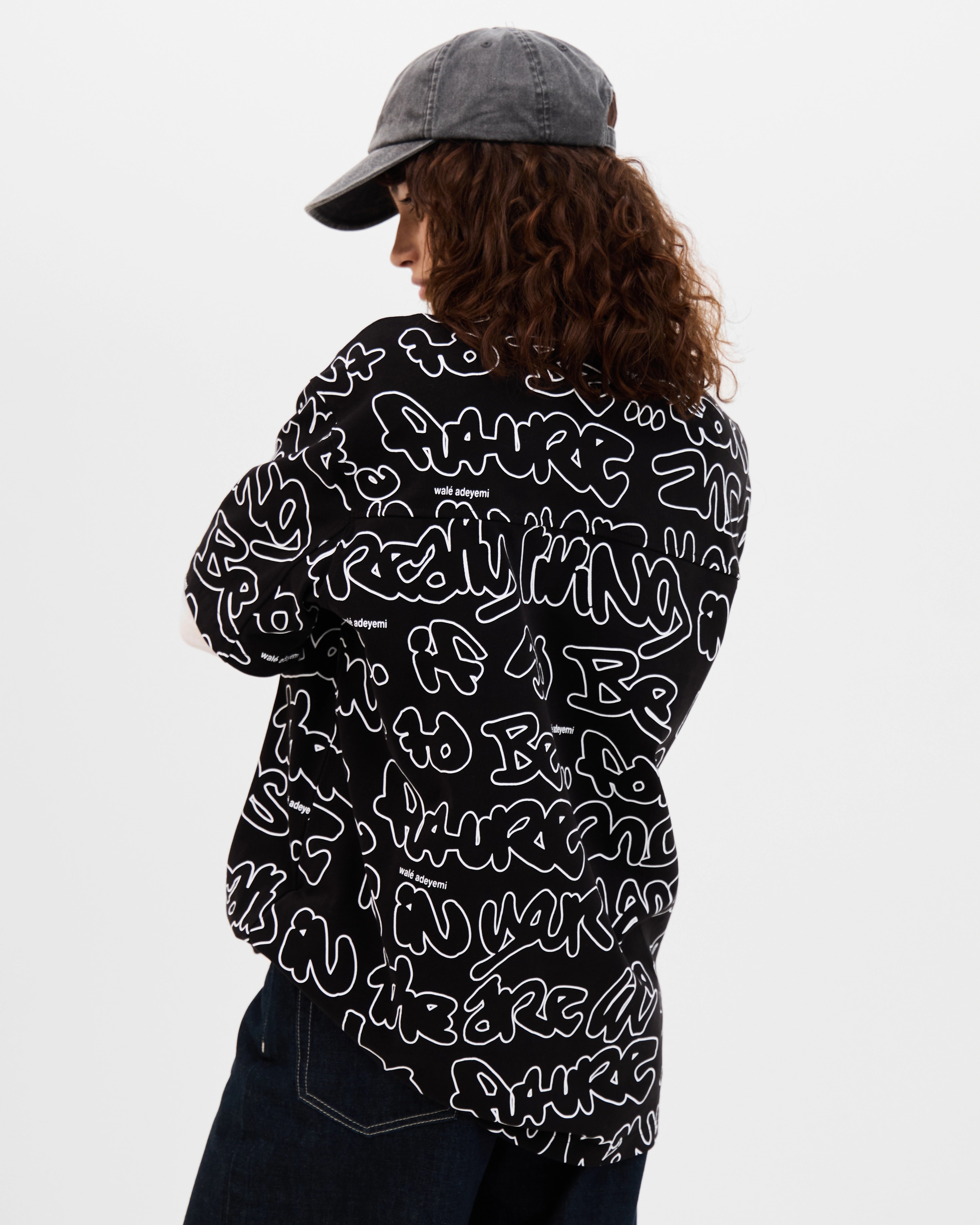 Model wearing the Walé Adeyemi AOP Graf T-shirt in Black, back view