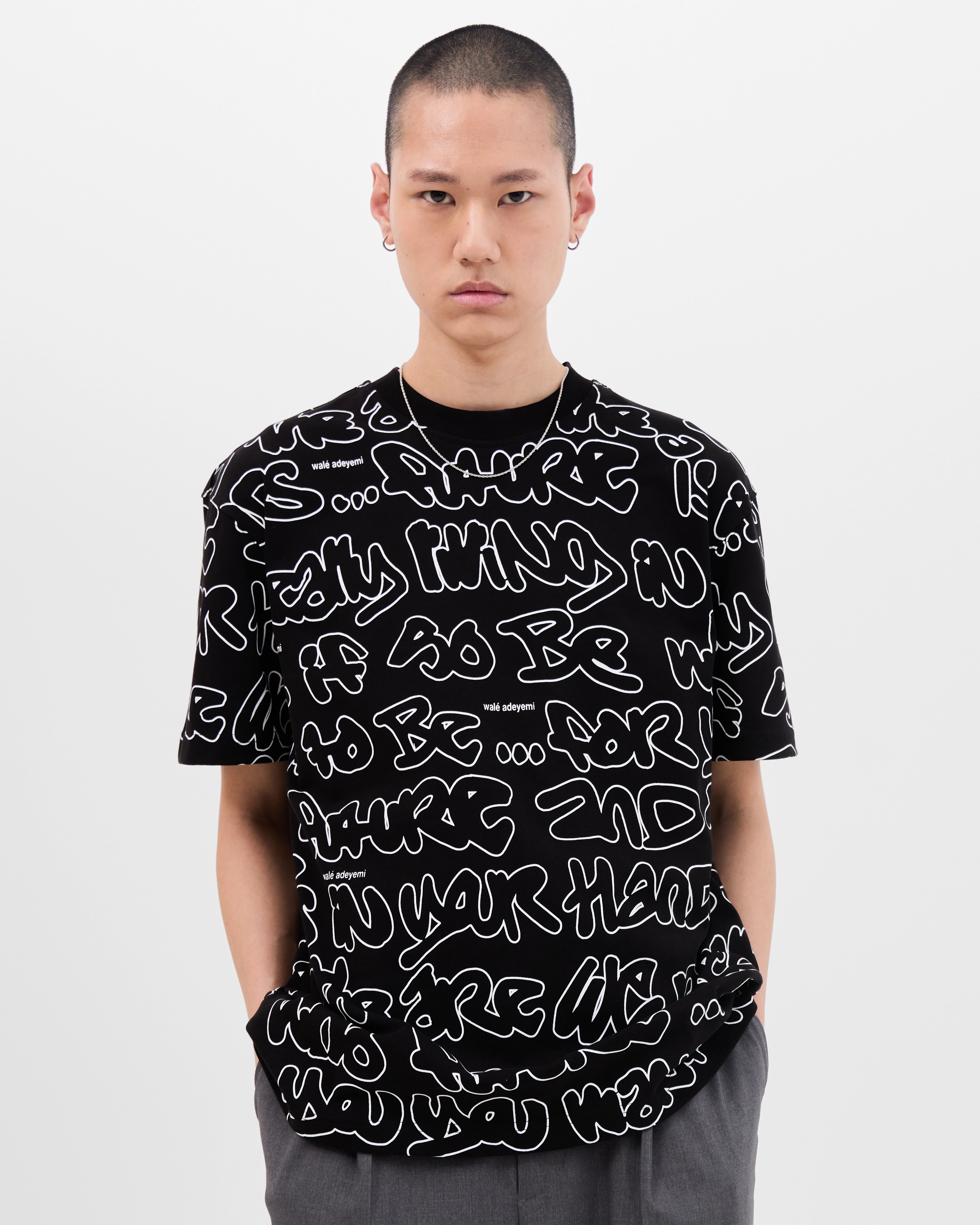 Model wearing the Walé Adeyemi AOP Graf T-shirt in Black, front view