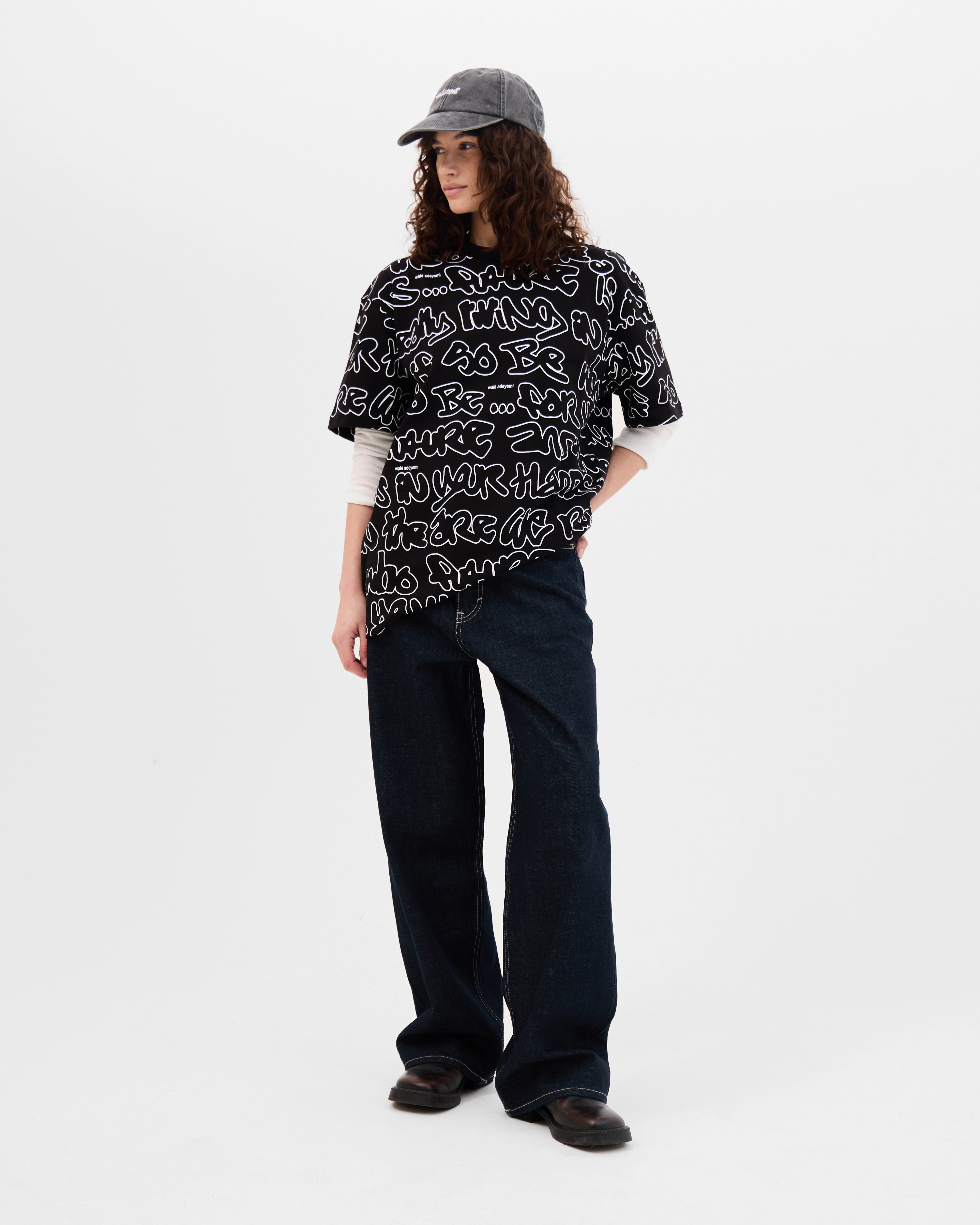 Model wearing the Walé Adeyemi AOP Graf T-shirt in Black, alternate front view