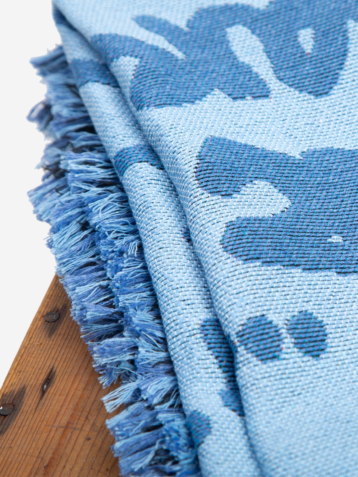 Graf Woven Throw reverse corner detail showing rust artwork and contrasting fringe